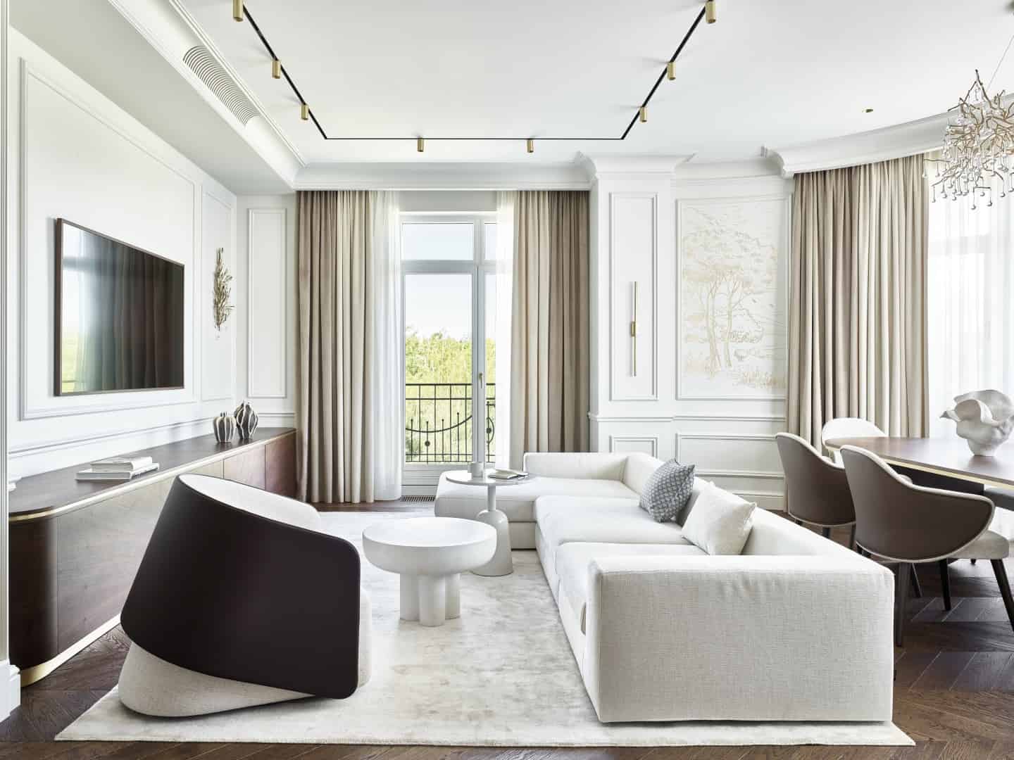 Modern luxury living room with elegant white walls, beige curtains, and contemporary furniture including a white sofa, dark wood accent pieces, and decorative art, showcasing upscale interior design.