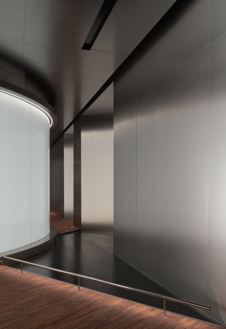 Angular Interfaces Angled partitions integrating interactive displays within reflective envelopes.