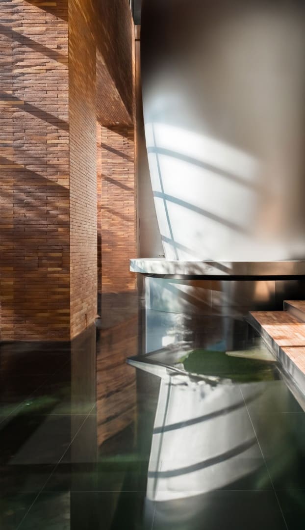 Exhibit Pods Floating exhibit pods reflected in glossy surfaces within a dimmed gallery.