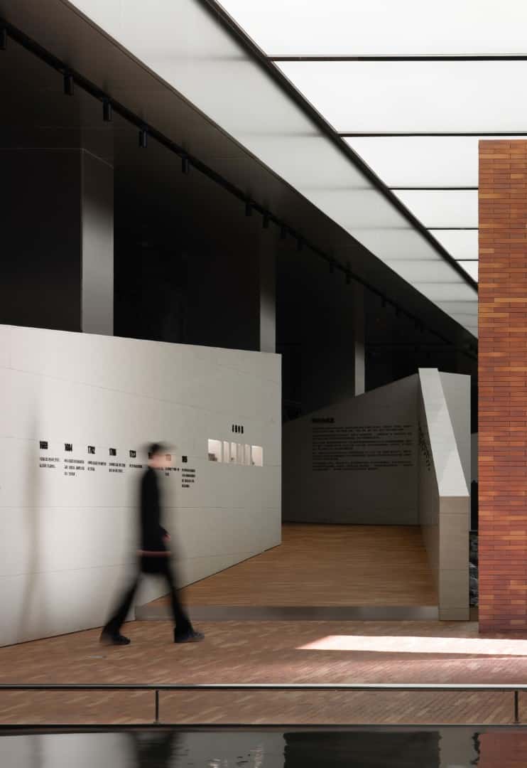 Monumental Columns Stainless columns forming a colonnade that frames processional movement.