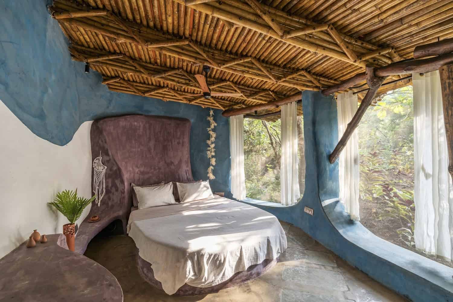 Court to Room Room opening to a private courtyard with earthen walls and filtered daylight.