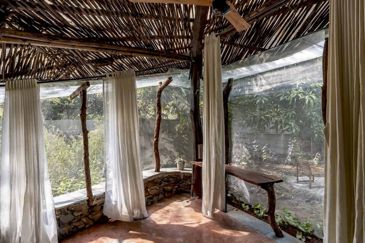 Bathing Court Private bathing courtyard with earthen walls, plants, and open sky.