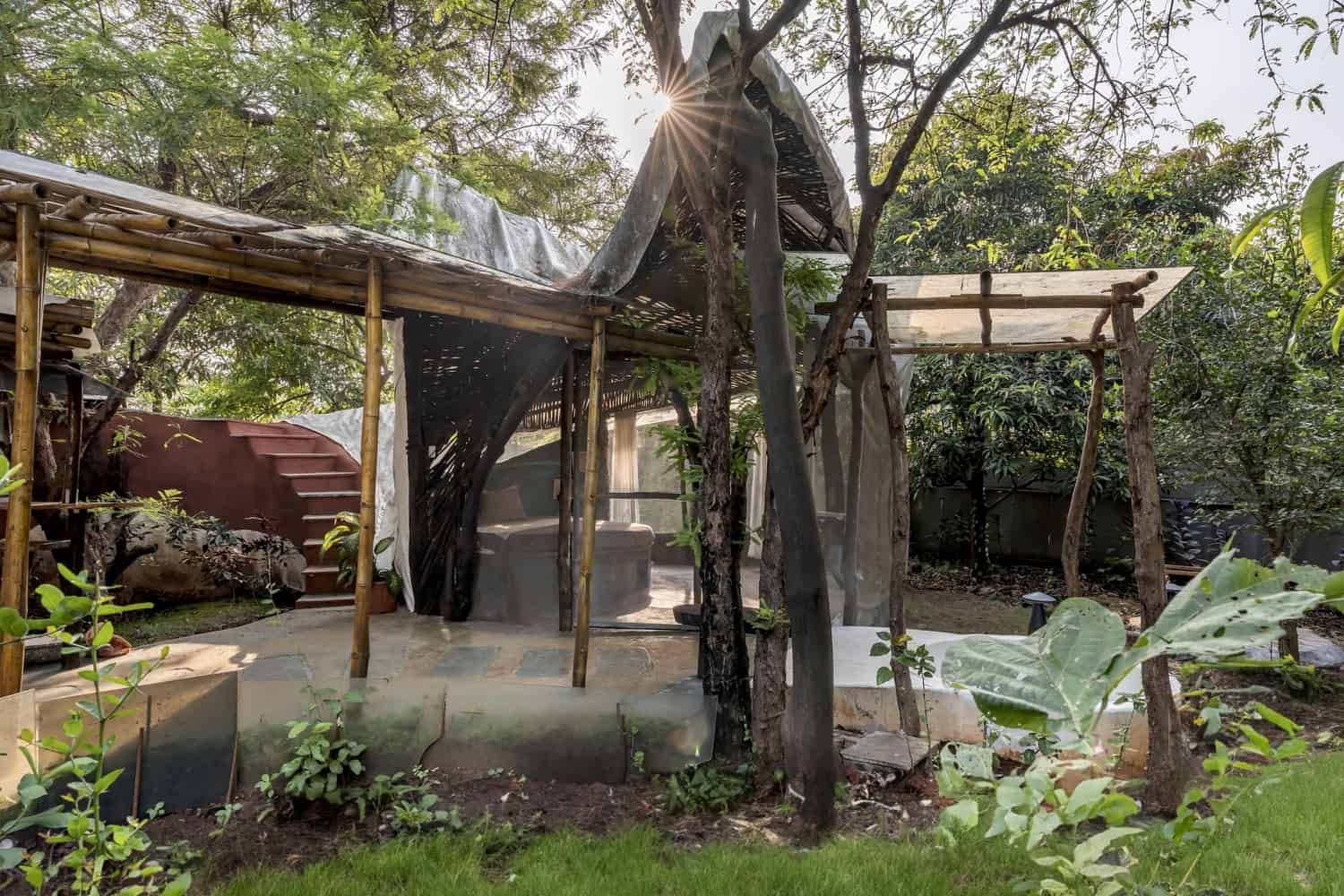 Courtyard as Climatic Heart Central courtyard with curved earthen walls admitting soft daylight into Maativan Farmhouse.