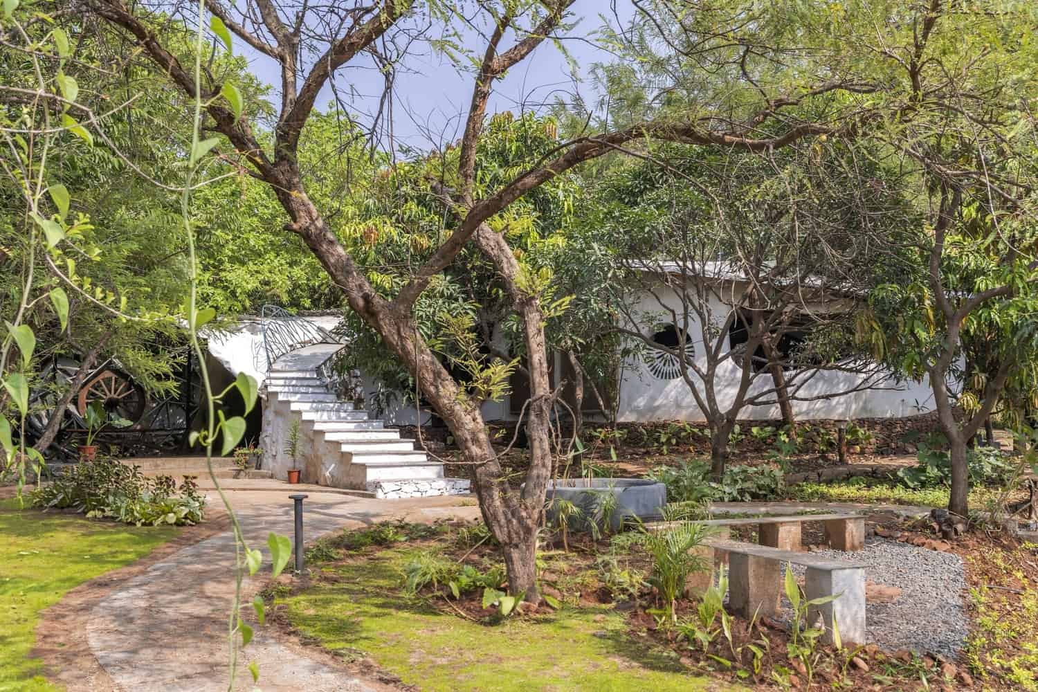 Maativan Farmhouse — Forest Edge Arrival Earth-toned farmhouse nestled among trees at the edge of Tansa Reserved Forest near Mumbai.
