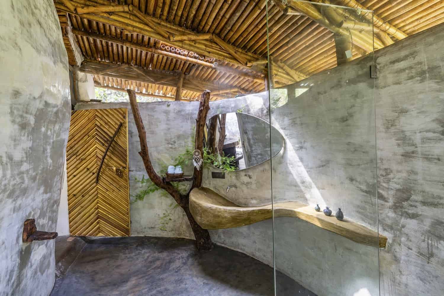Forest Veranda Veranda with bamboo structure and earthen wall overlooking dense forest understory.