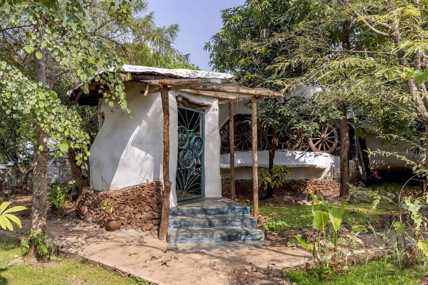 Path of Clay & Stone Exterior path of Kota stone and compacted earth leading between curved walls.