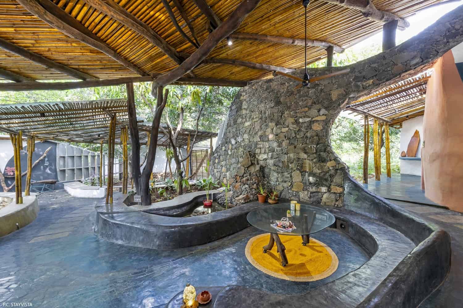 Basalt & Bamboo Random-rubble basalt base meeting bamboo and timber members at a shaded threshold.