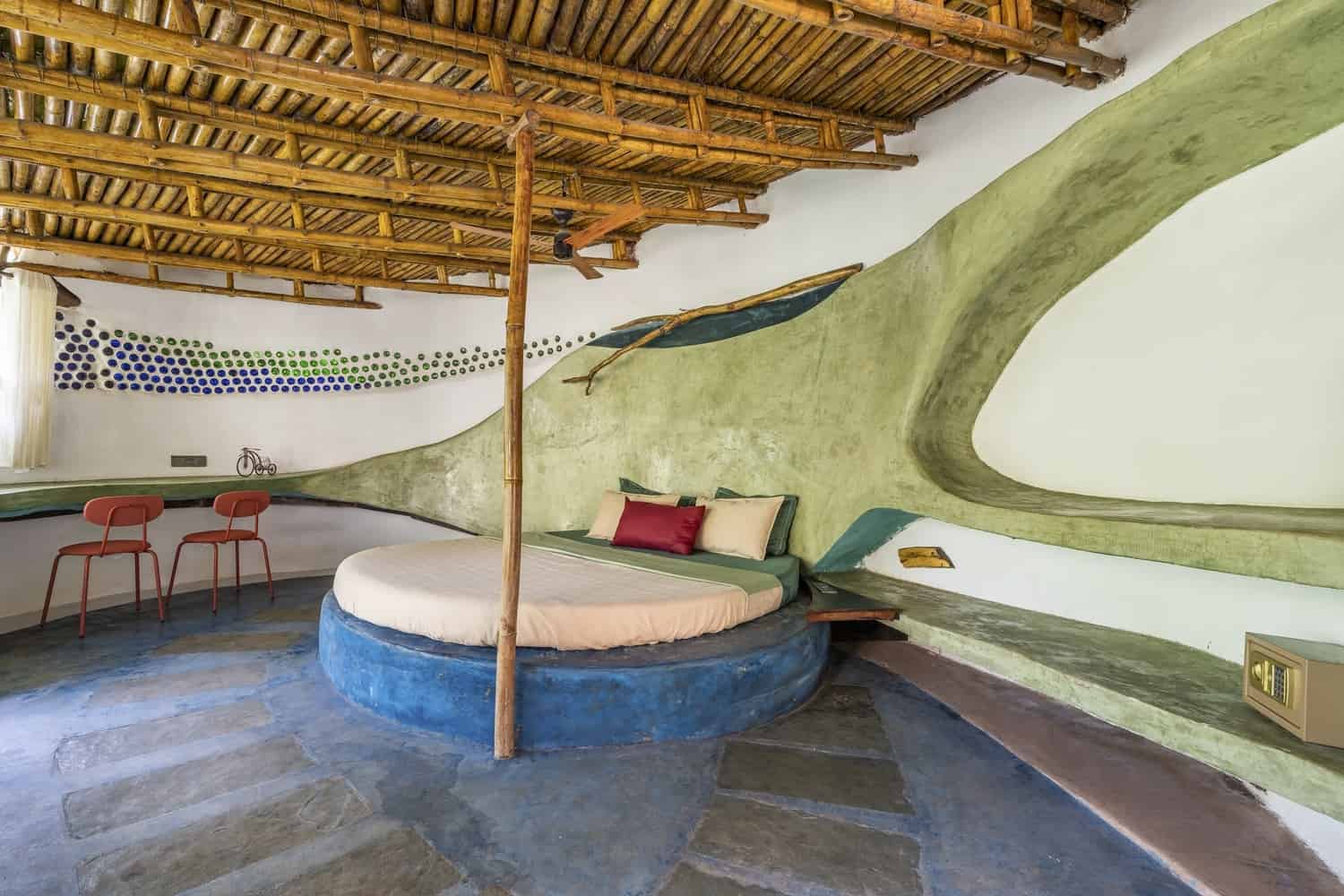 Shaded Eaves Deep roof overhangs and earthen walls forming cool verandas around a court.