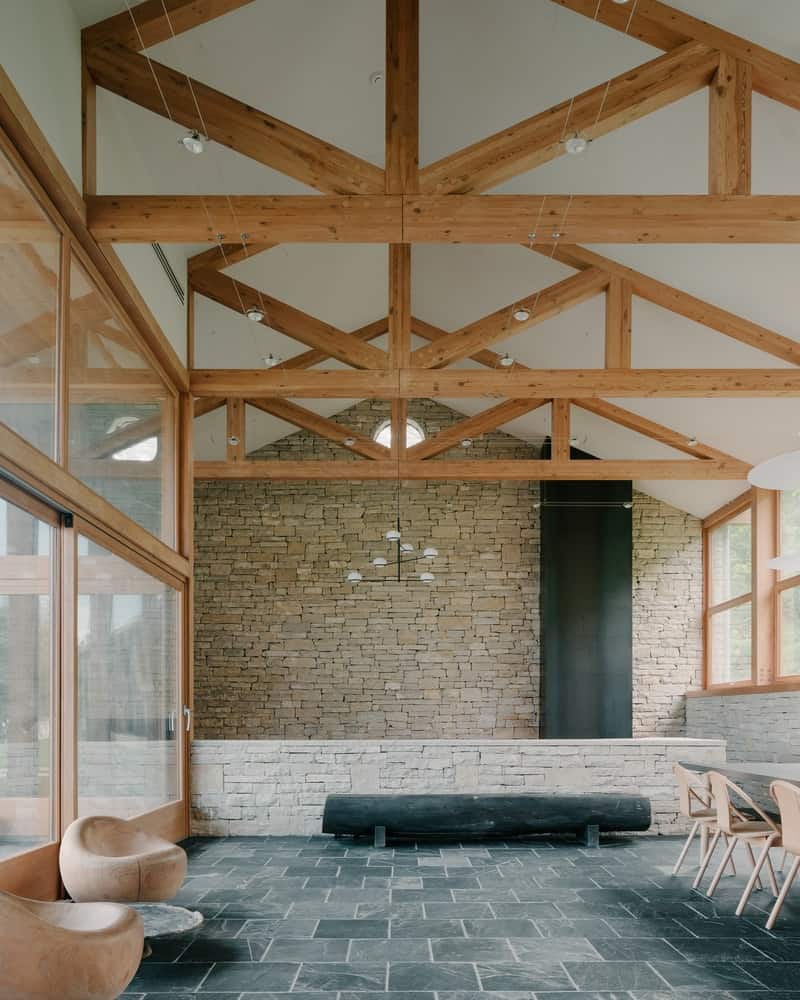 Courtyard Thresholds Sheltered outdoor threshold with stone paving and timber soffit forming a calm transition zone.