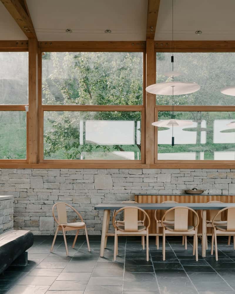 Garden Rooms Low stone walls and soft planting define intimate outdoor living rooms beside the house.