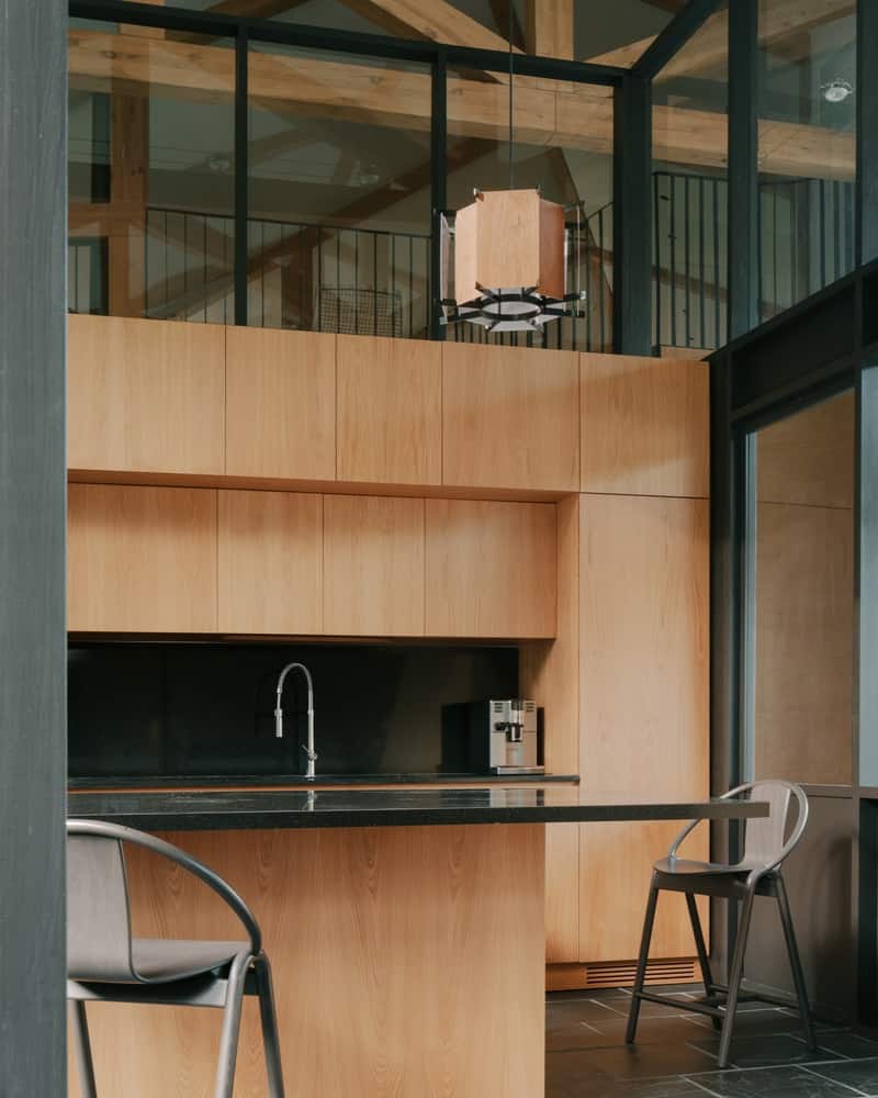 Sheltered Entry Court Entry court with stone paving and timber canopy forming a welcoming, protected threshold.