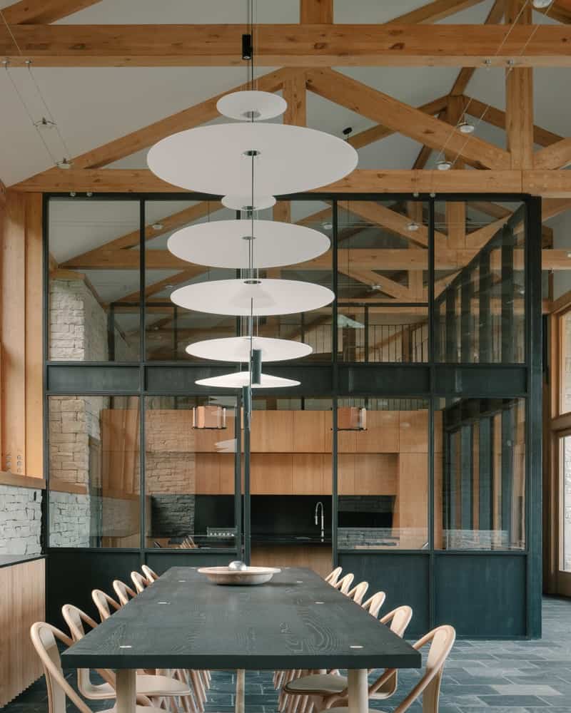 Timber Craft Detail of timber joinery and soffit meeting stone wall, showing precise craftsmanship.