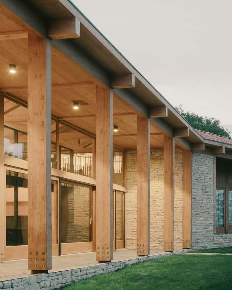 Perpendicular Cellar Wing Stone-and-timber cellar volume set perpendicular to the main house, shaping a sheltered court.