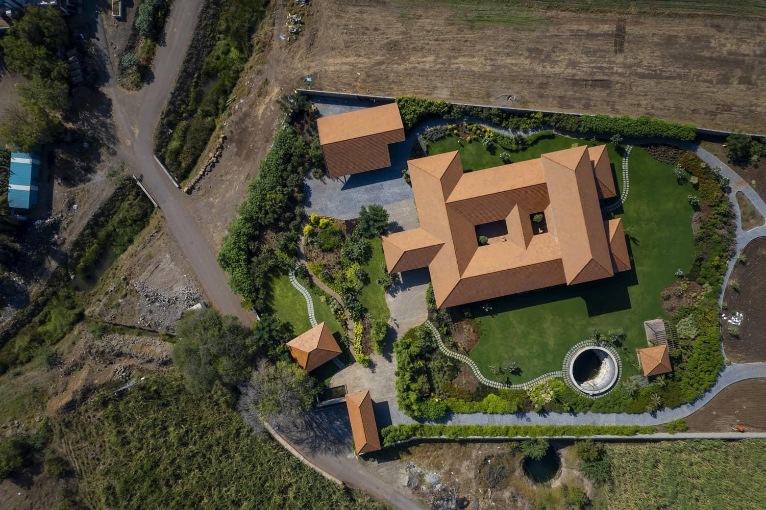 Terrace Edge Terrace overlooking farmland, framed by brick piers and a pitched roof eave.