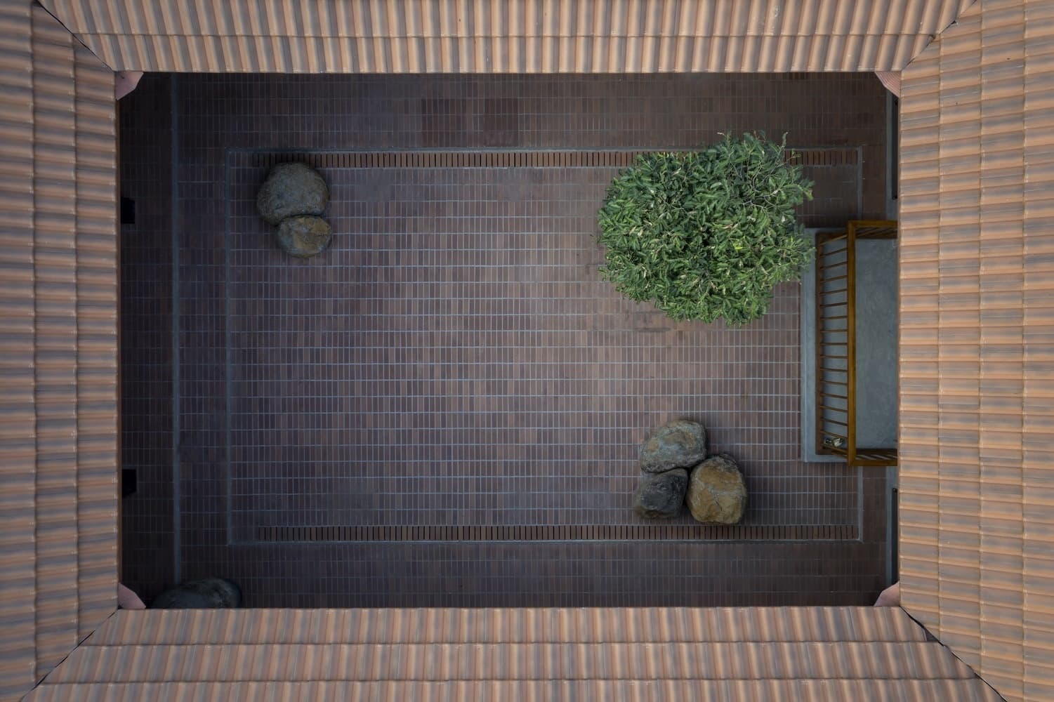 Gabled Silhouette Pitched roof silhouette against the evening sky, framed by deep overhangs.