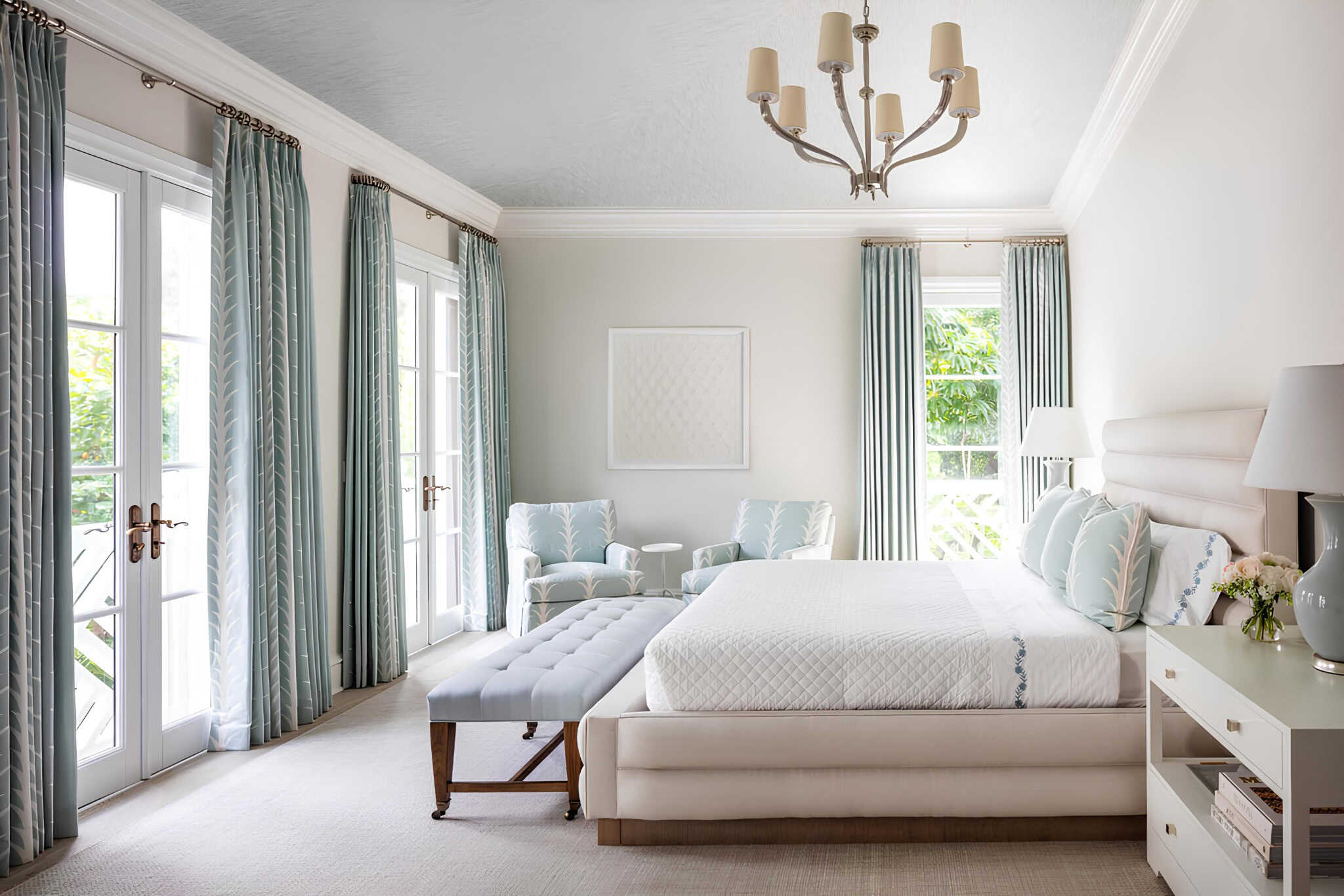 Mediterranean Bedroom Miami Aqua Curtains Classic Mediterranean bedroom with aqua curtains, white upholstery, and a chandelier.