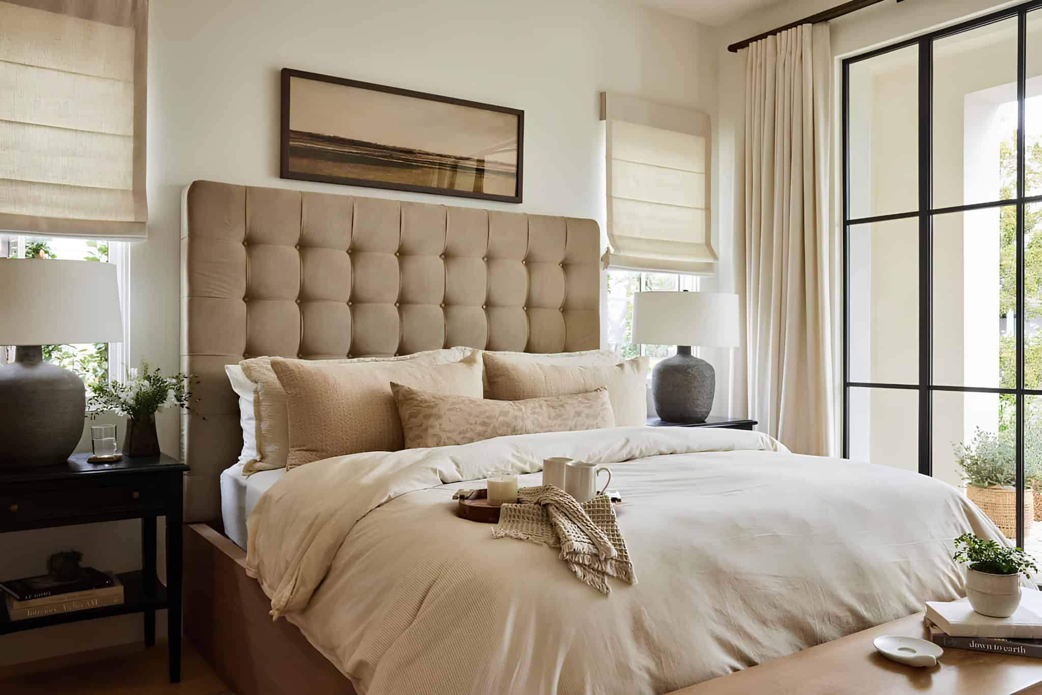 Mediterranean Bedroom Orange County Neutral Mediterranean bedroom with tufted headboard and layered textures.