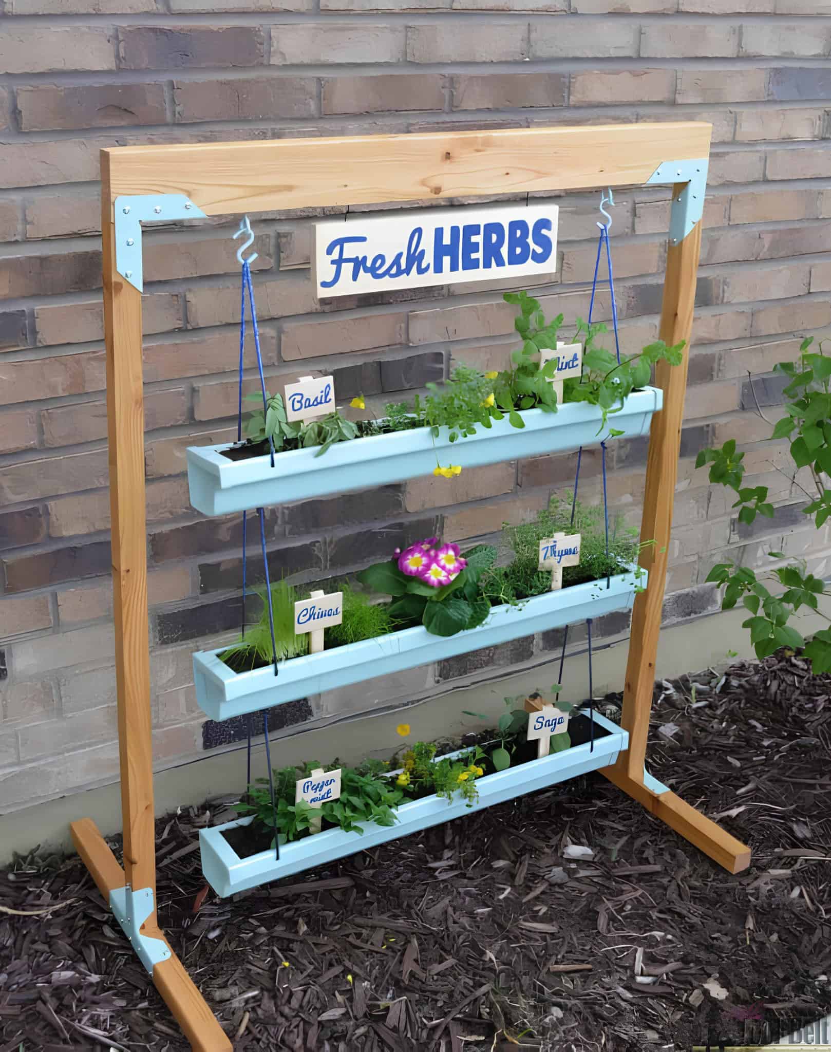 Hanging herb garden using painted gutters and wooden frame