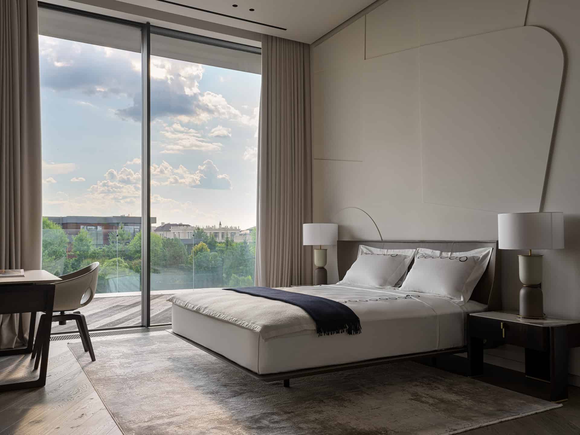 Bedroom with Floor to Ceiling Window Spacious bedroom with serene view through floor-to-ceiling glass doors.