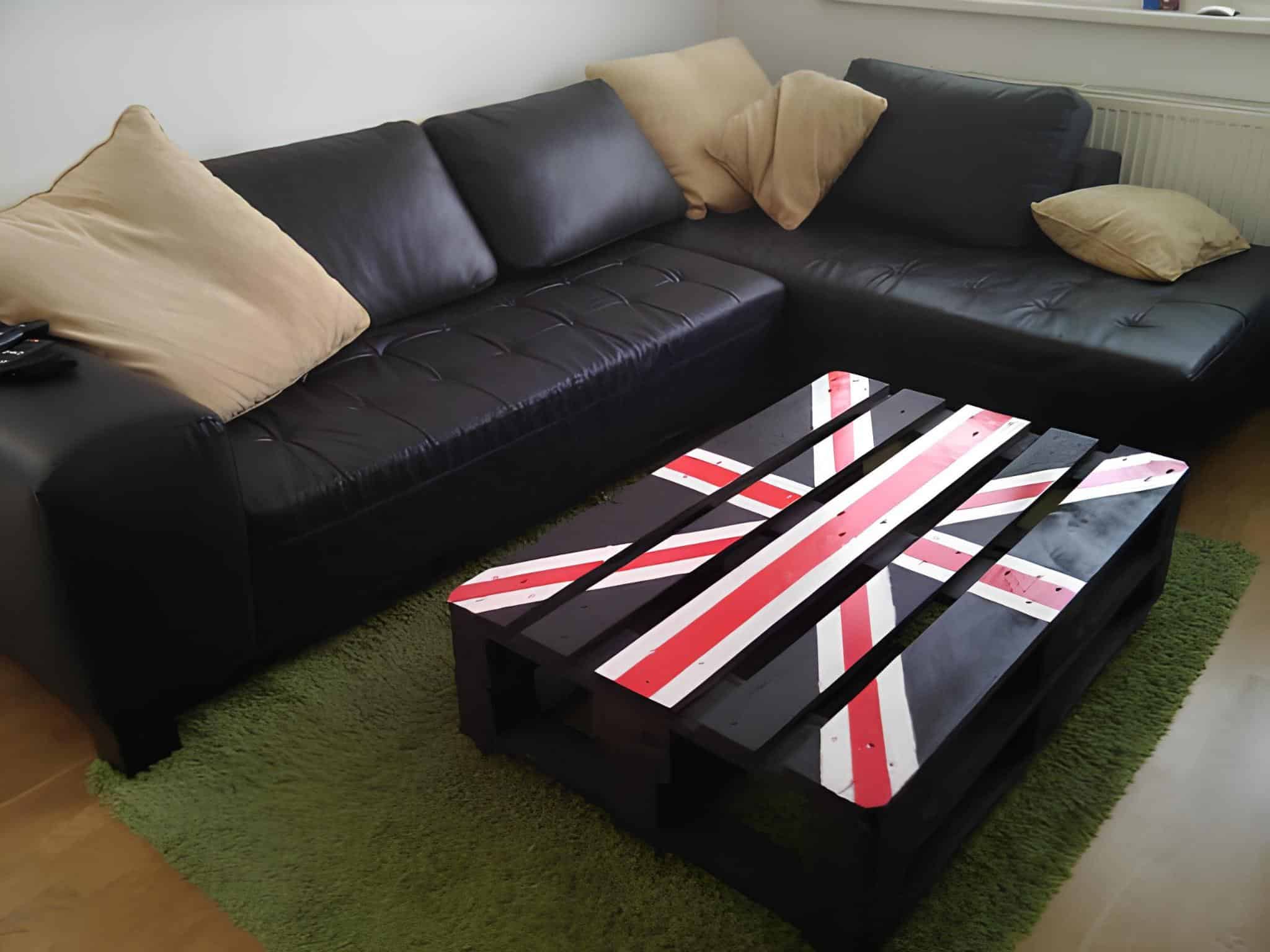 Bold coffee table made from black painted pallet with Union Jack design
