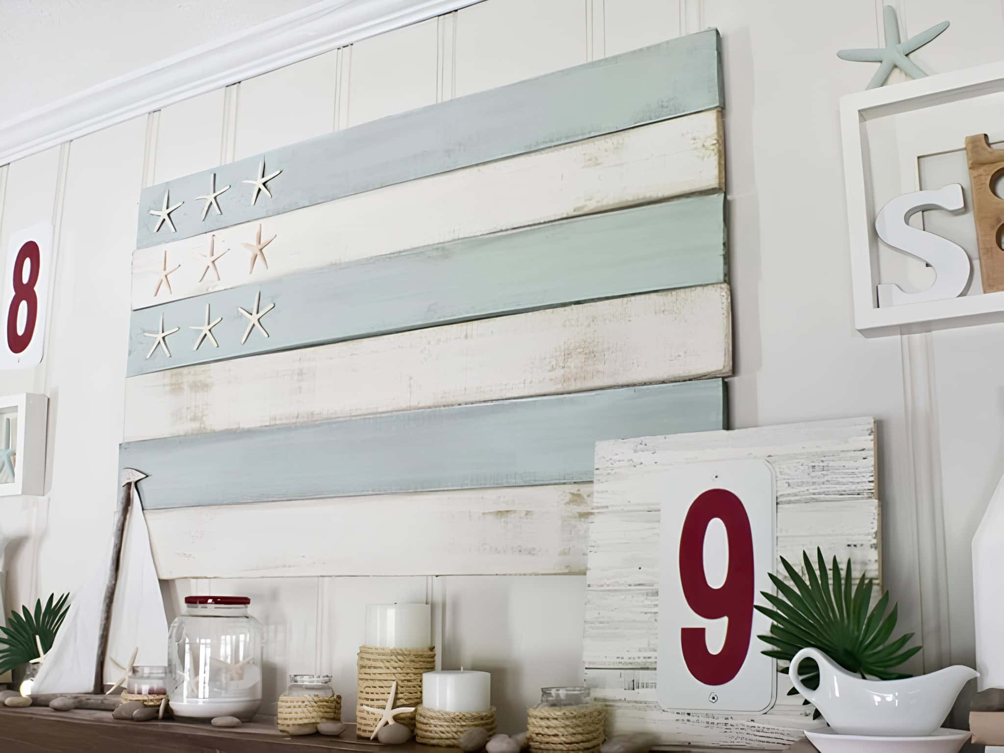Beach-style wall art mimicking a flag design with starfish, in faded blue and white tones.
