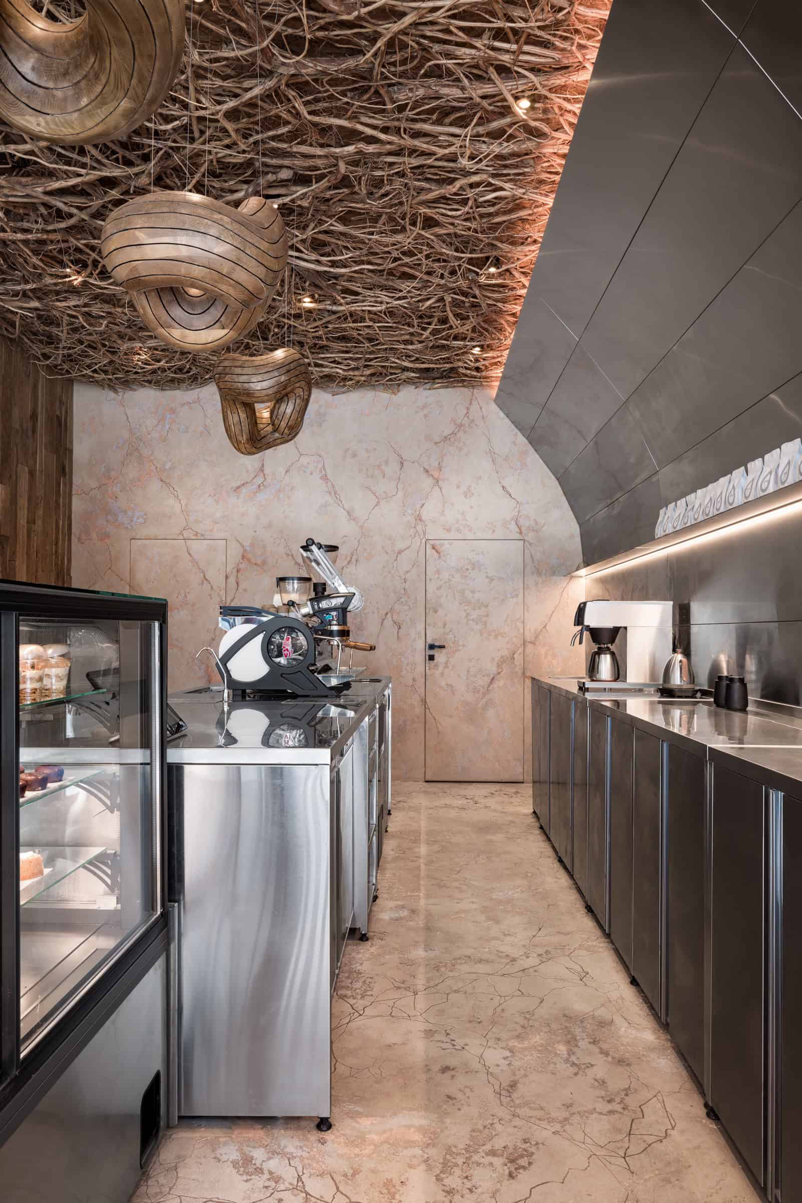 Coffee Shop Kovel Back Counter View Back view of the coffee counter showcasing espresso machines and stainless steel cabinetry