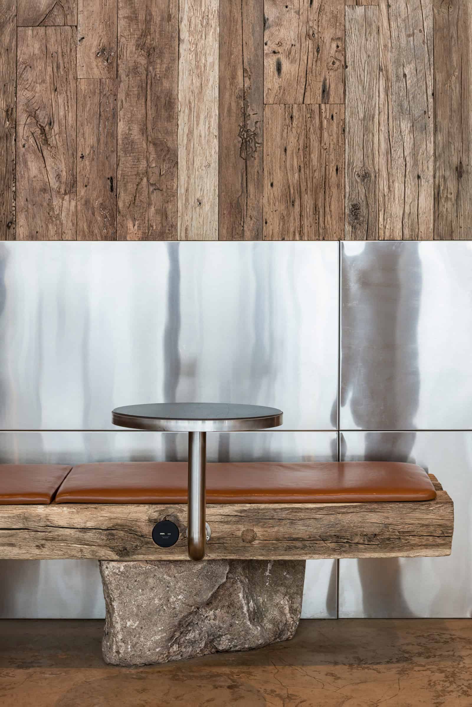 Coffee Shop Kovel Bench Steel Wood Detail Detail of bench structure combining steel supports, aged wood, and rock base
