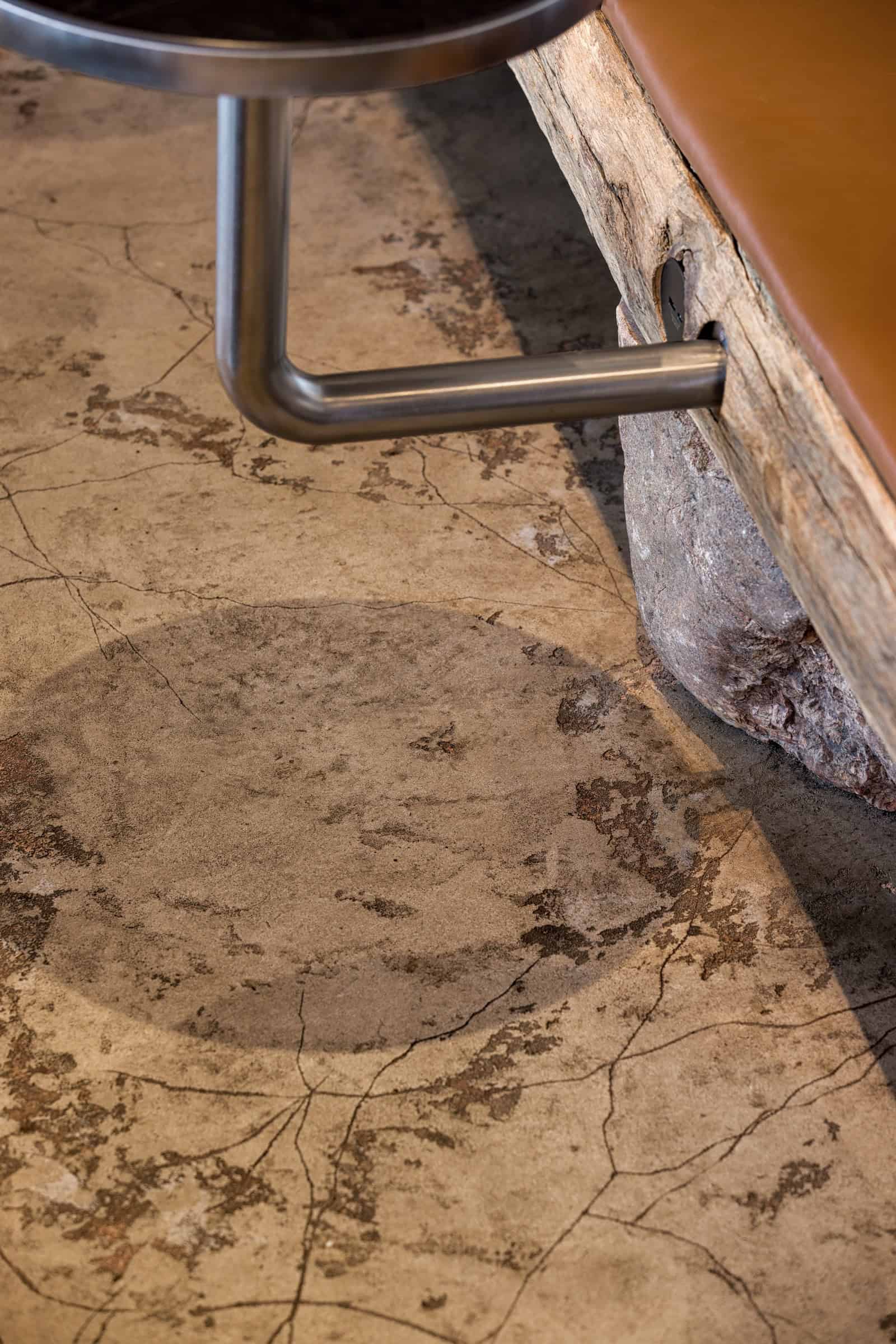 Coffee Shop Kovel Concrete Floor Detail Textured concrete flooring detail with table shadow and bench base