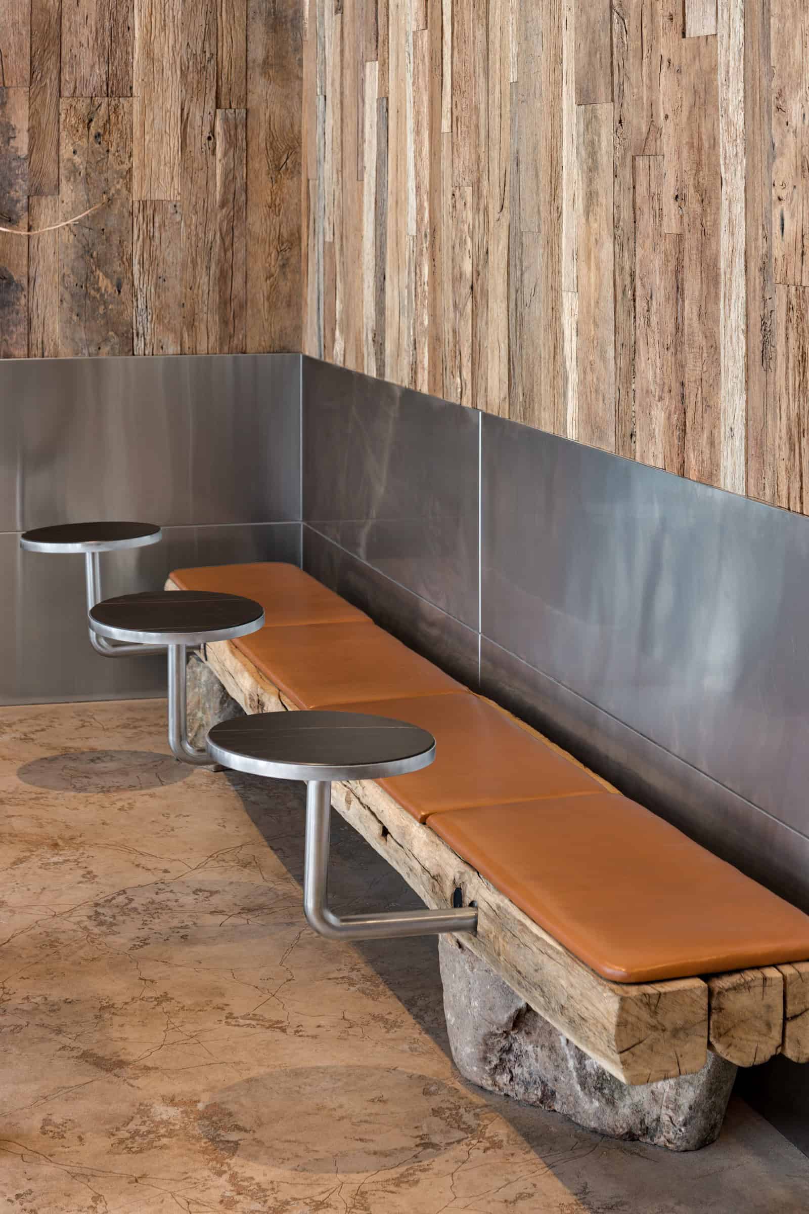 Coffee Shop Kovel Natural Wood Chairs Close-up of wooden chairs with leather cushions and grain-rich wood surfaces