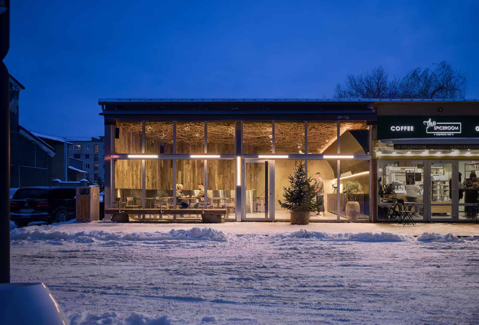 Coffee Shop Kovel Nighttime Street View Exterior night view of Drop Coffee in Kovel, warmly lit with snow-covered surroundings