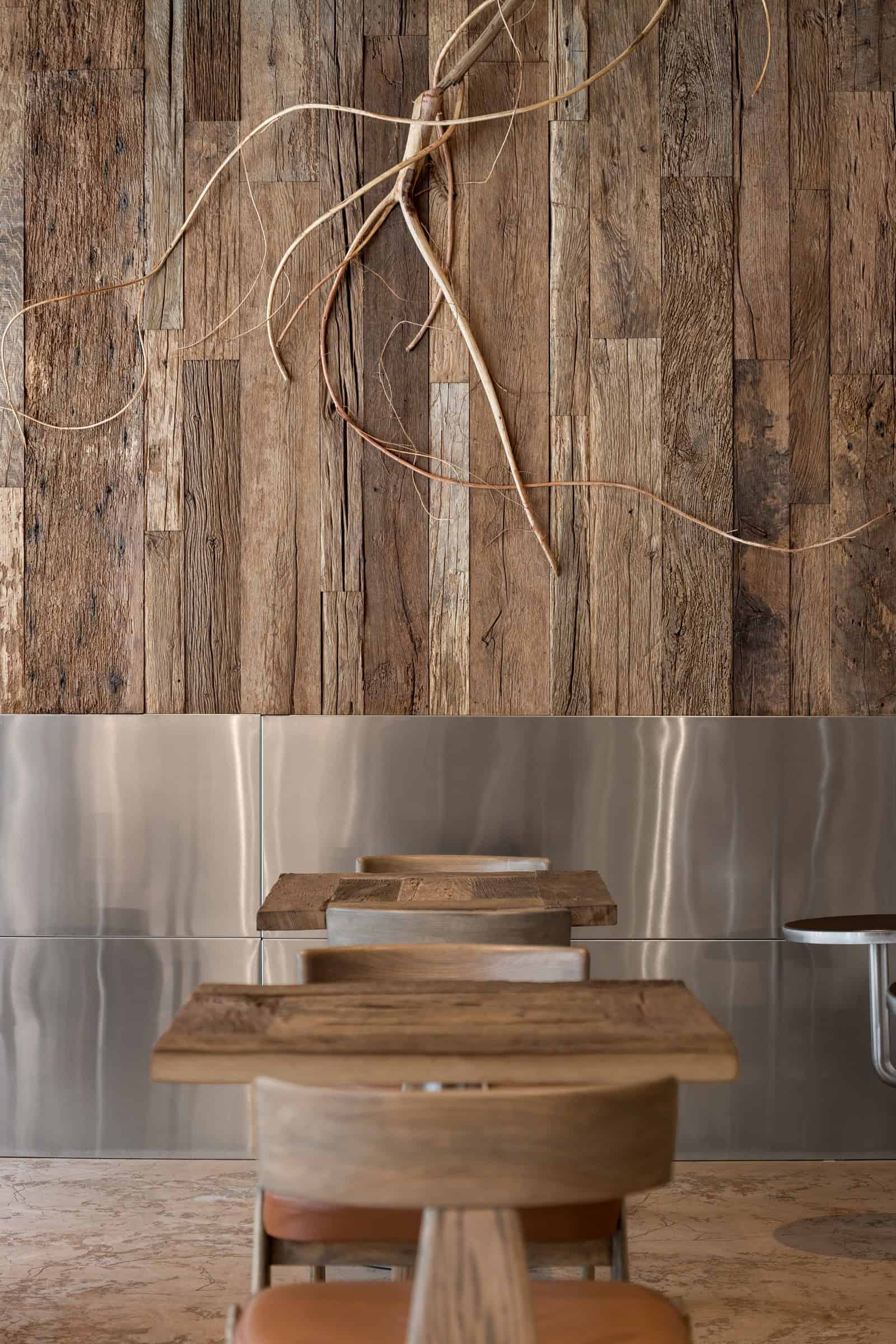 Coffee Shop Kovel Root Wall Sculpture Artistic root sculpture on reclaimed wood wall in coffee shop interior
