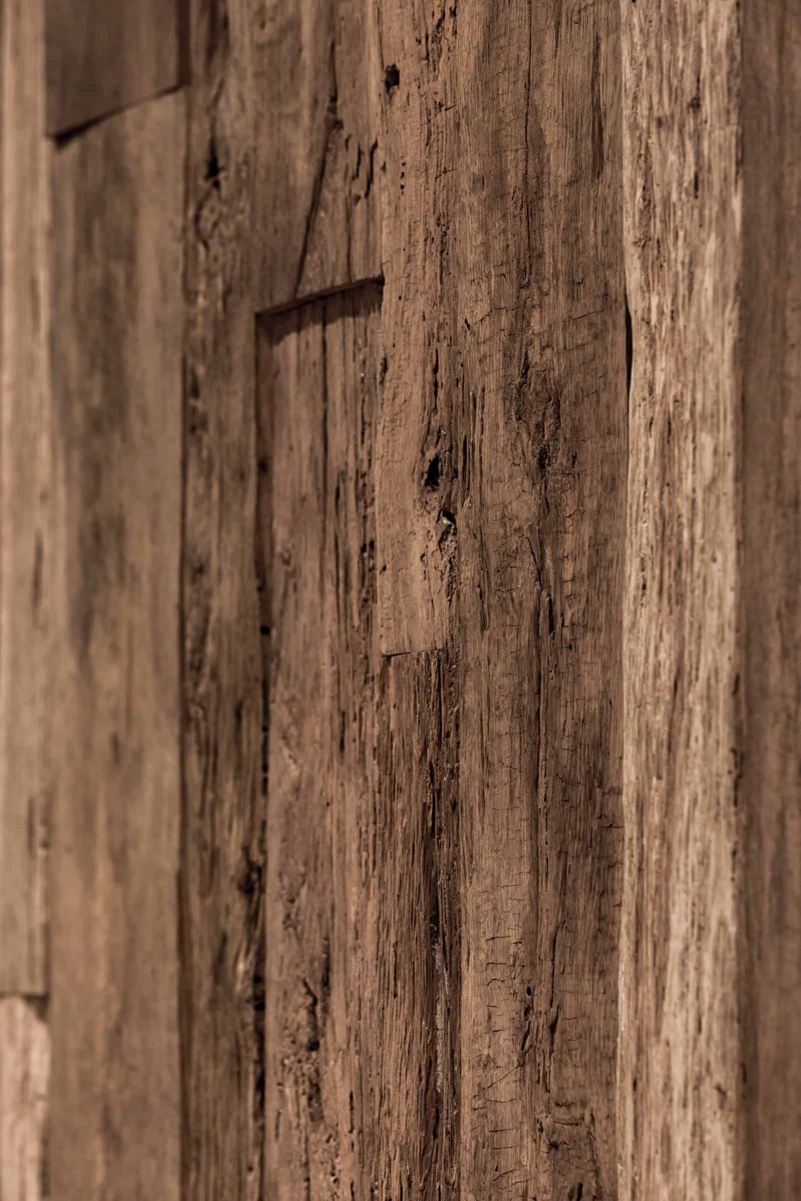 Coffee Shop Kovel Wood Panel Closeup 1 Close-up of aged wooden wall panels in natural brown tones