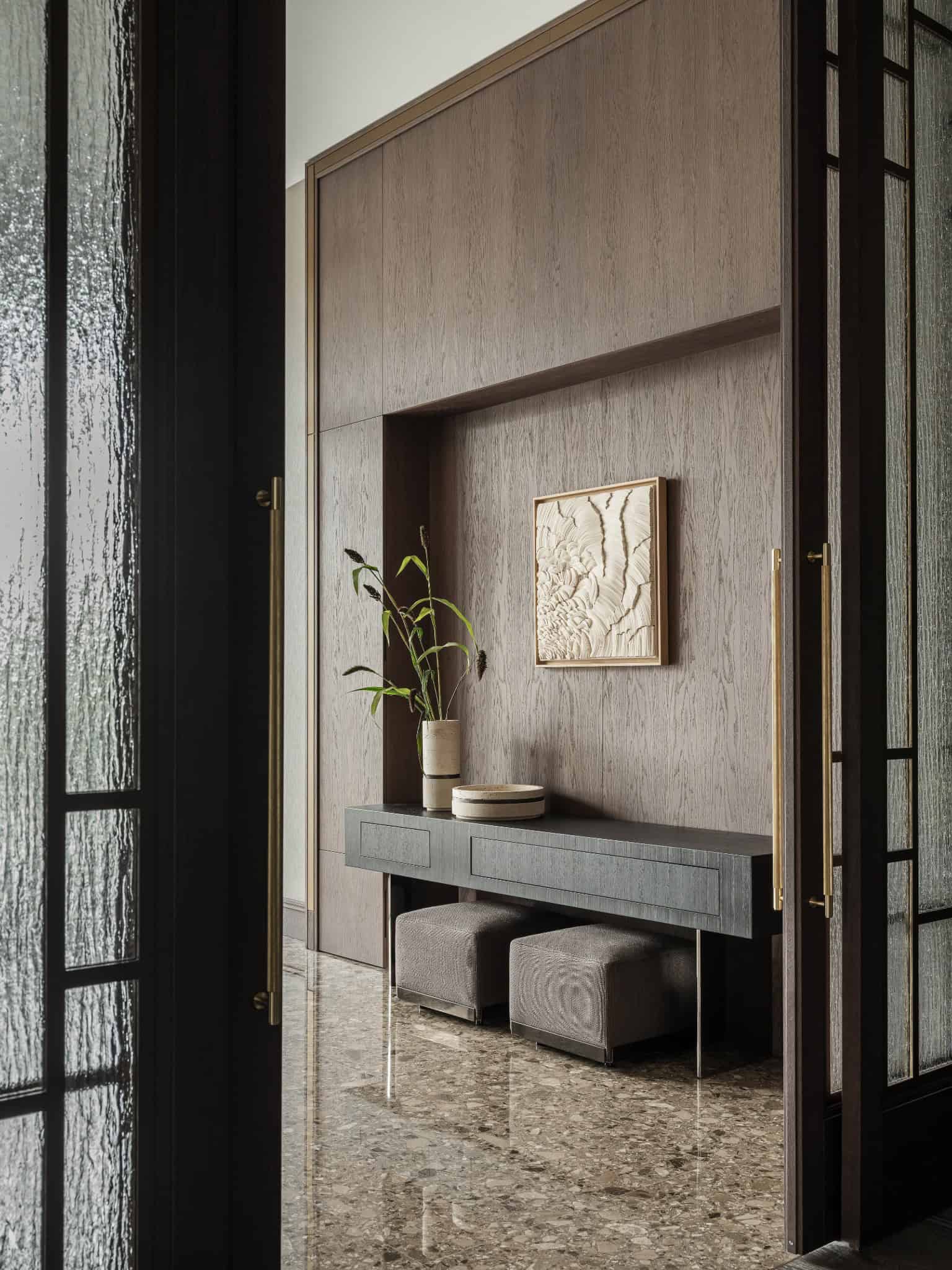 Console Table in Marble Floored Entry Elegant hallway with console table, vases, and marble flooring.