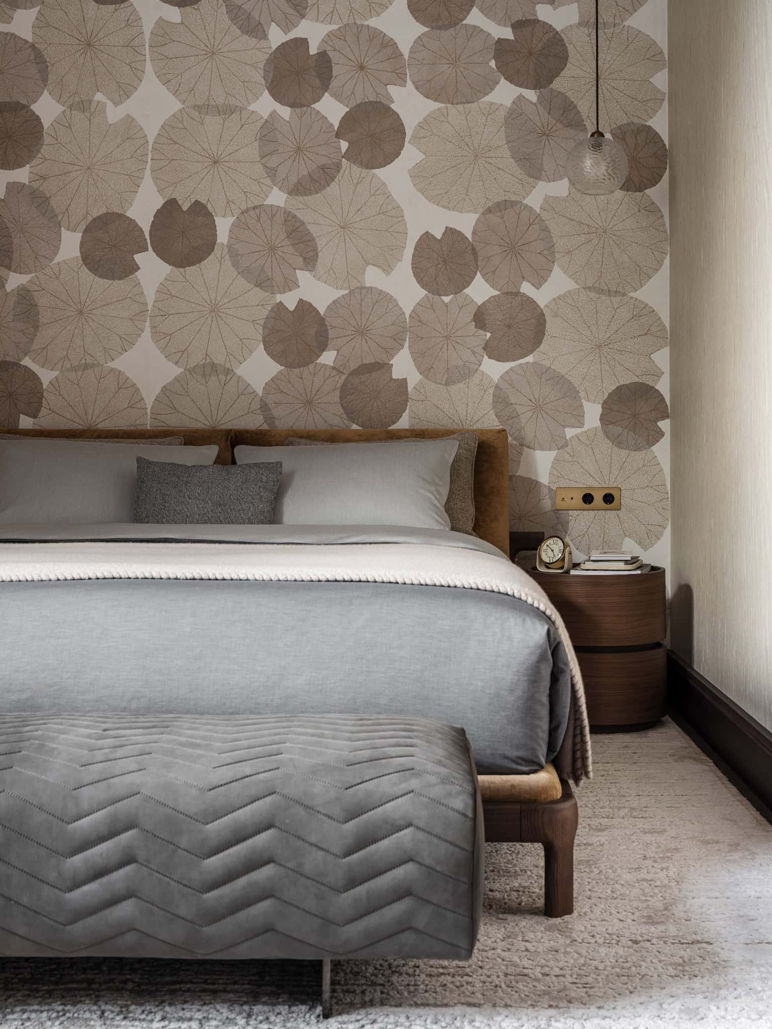 Contemporary Bedroom with Circle Wallpaper Muted modern bedroom with circular-patterned accent wall and soft lighting.
