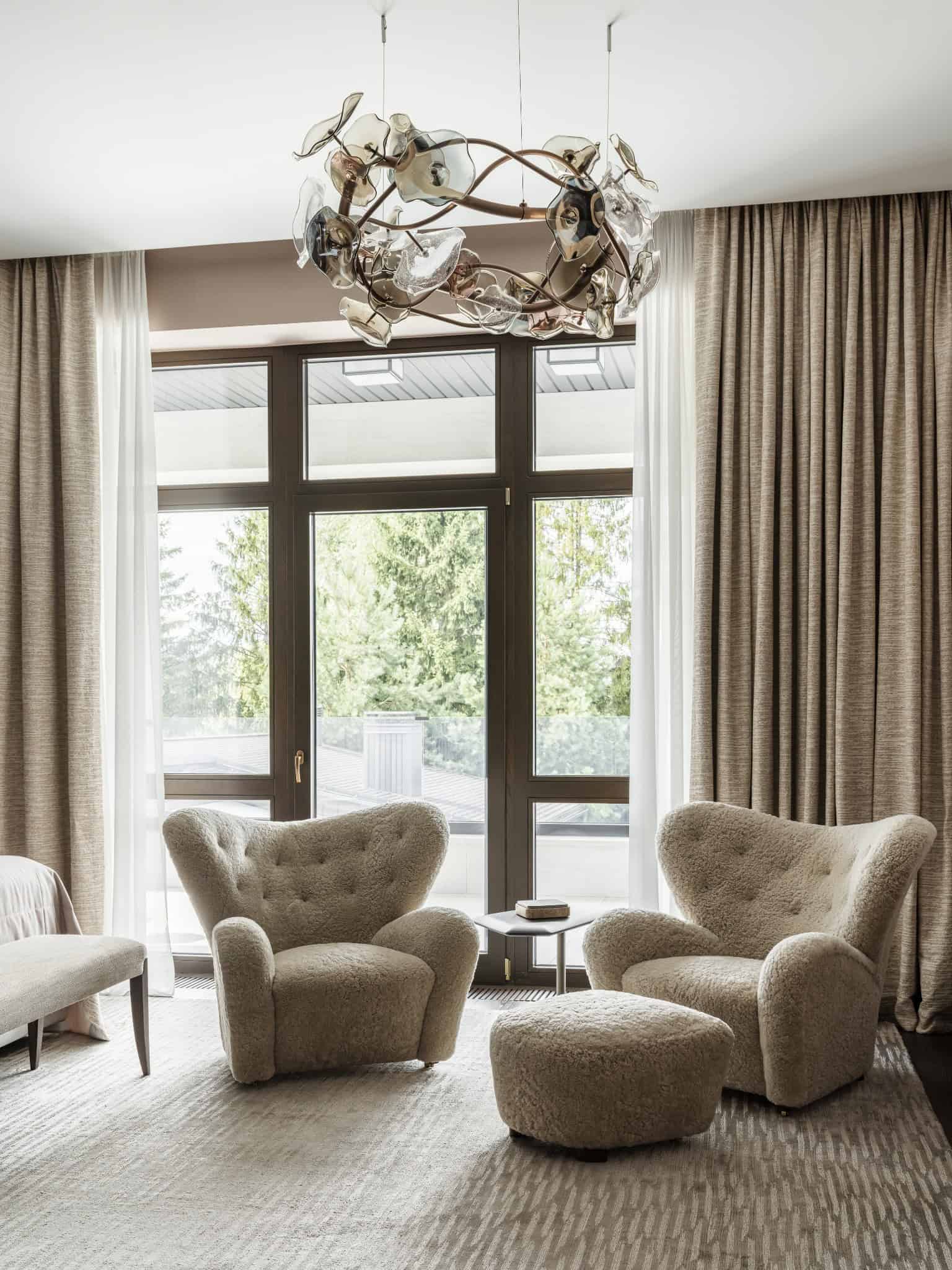 Cozy Lounge Corner with Shearling Chairs Comfortable corner seating with plush shearling chairs and glass chandelier.