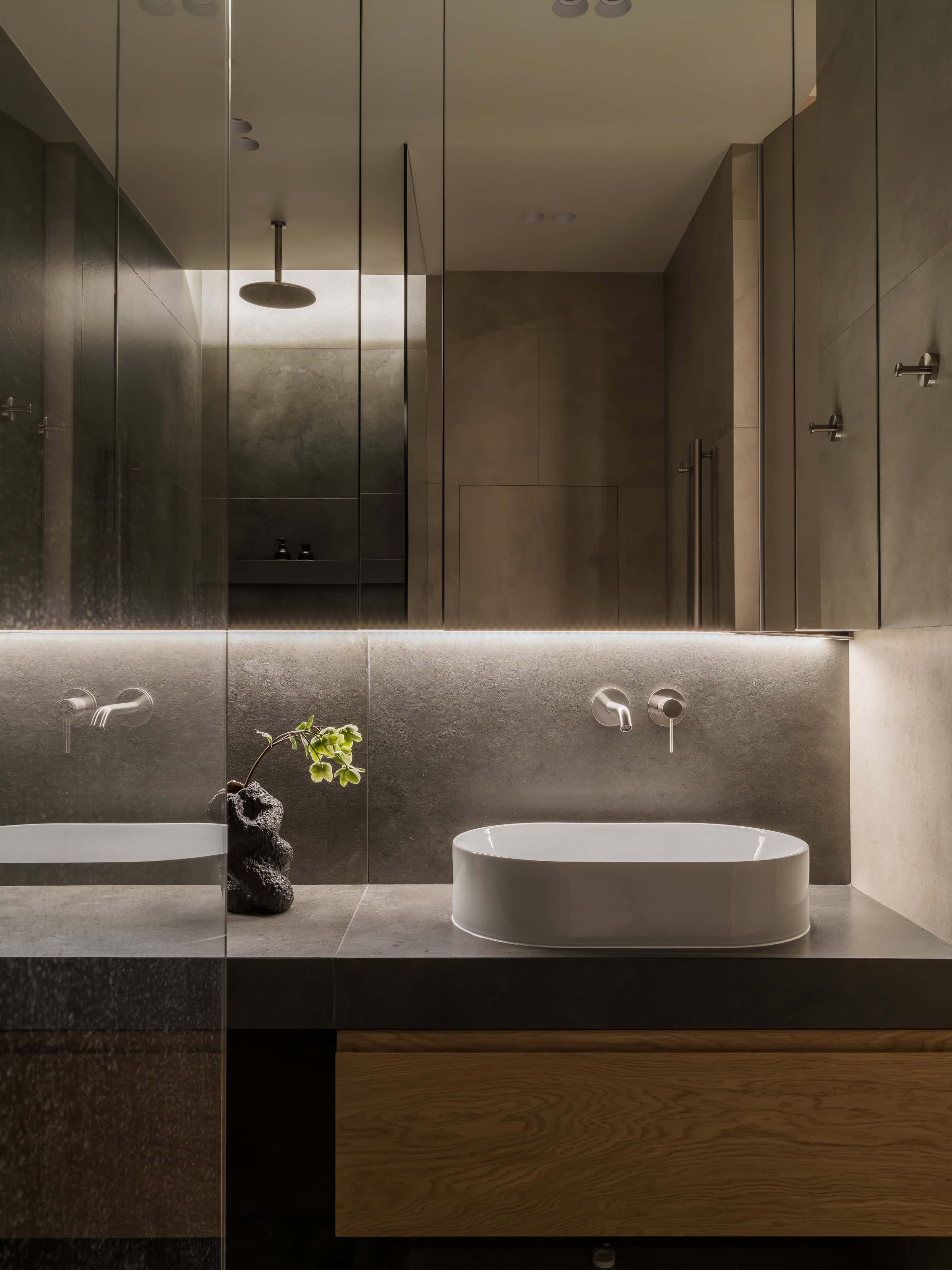 Double Vanity with LED Mirror Lighting Sleek double vanity with underlit mirrors and vessel sinks.