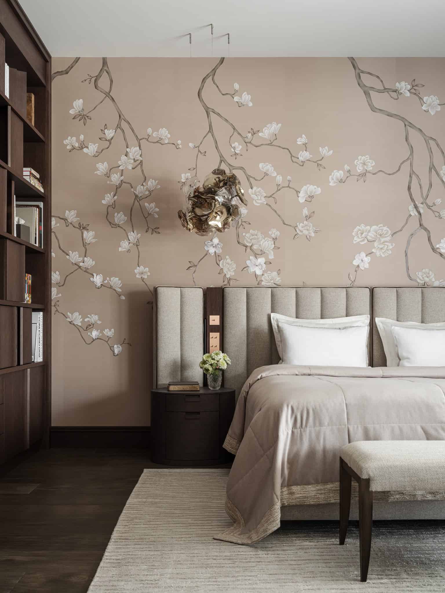 Elegant Bed Against Floral Accent Wall Modern bed with soft headboard set against delicate floral wall design.