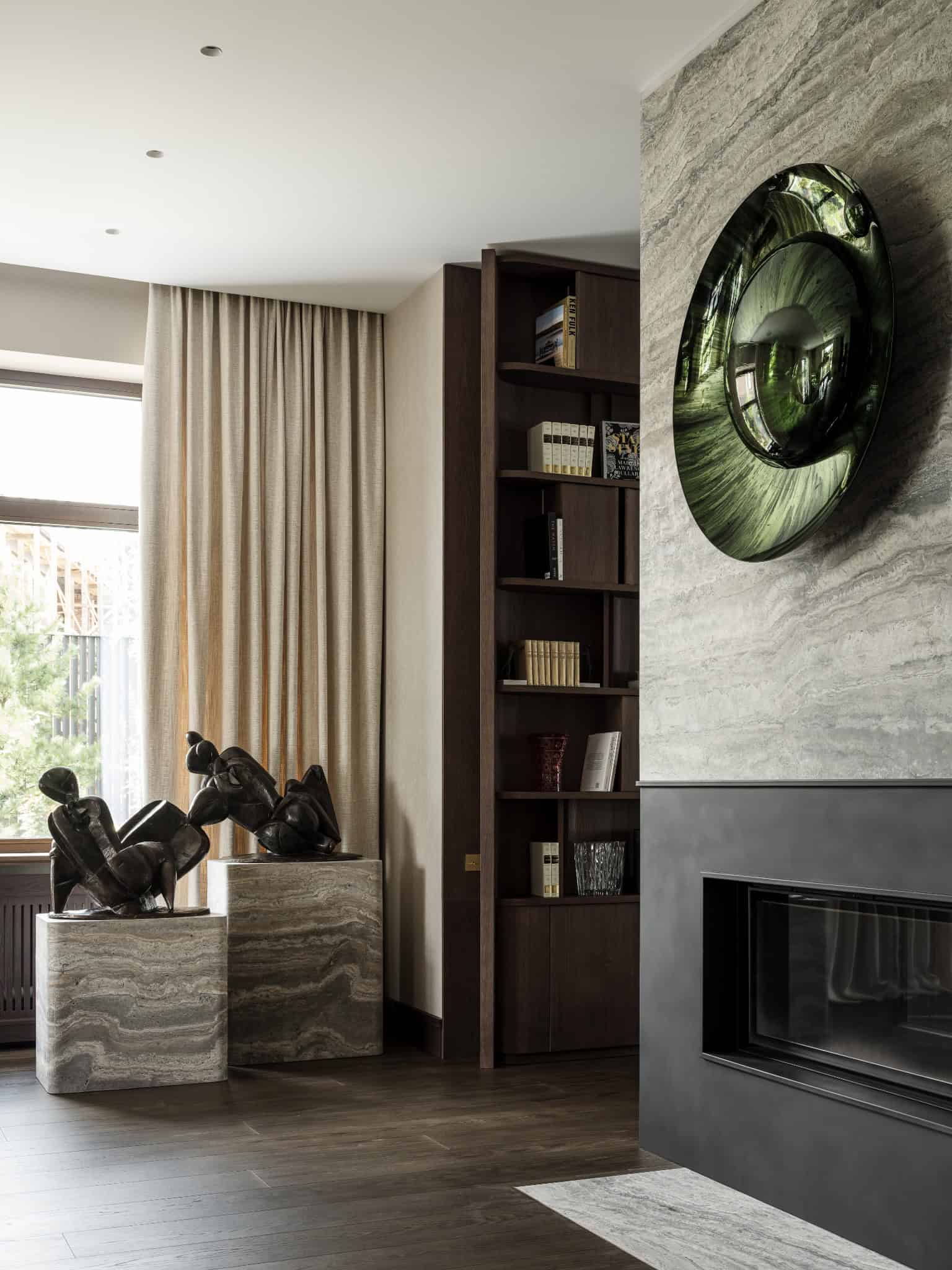 Fireplace and Marble Sculpture Corner Elegant living room corner with modern fireplace and marble pedestal sculptures.