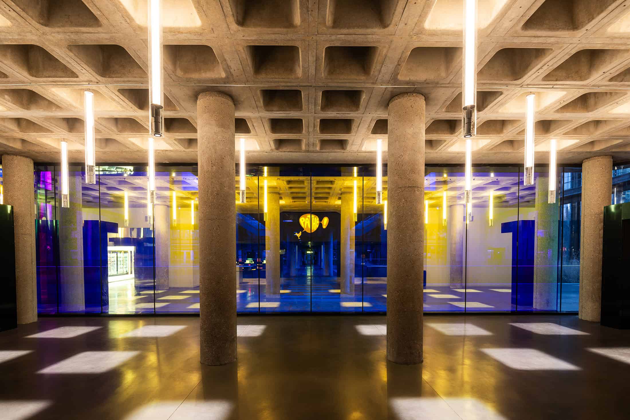 Geode Colored Glass Lobby Lobby with concrete pillars and colorful tinted glass panels at La Géode.