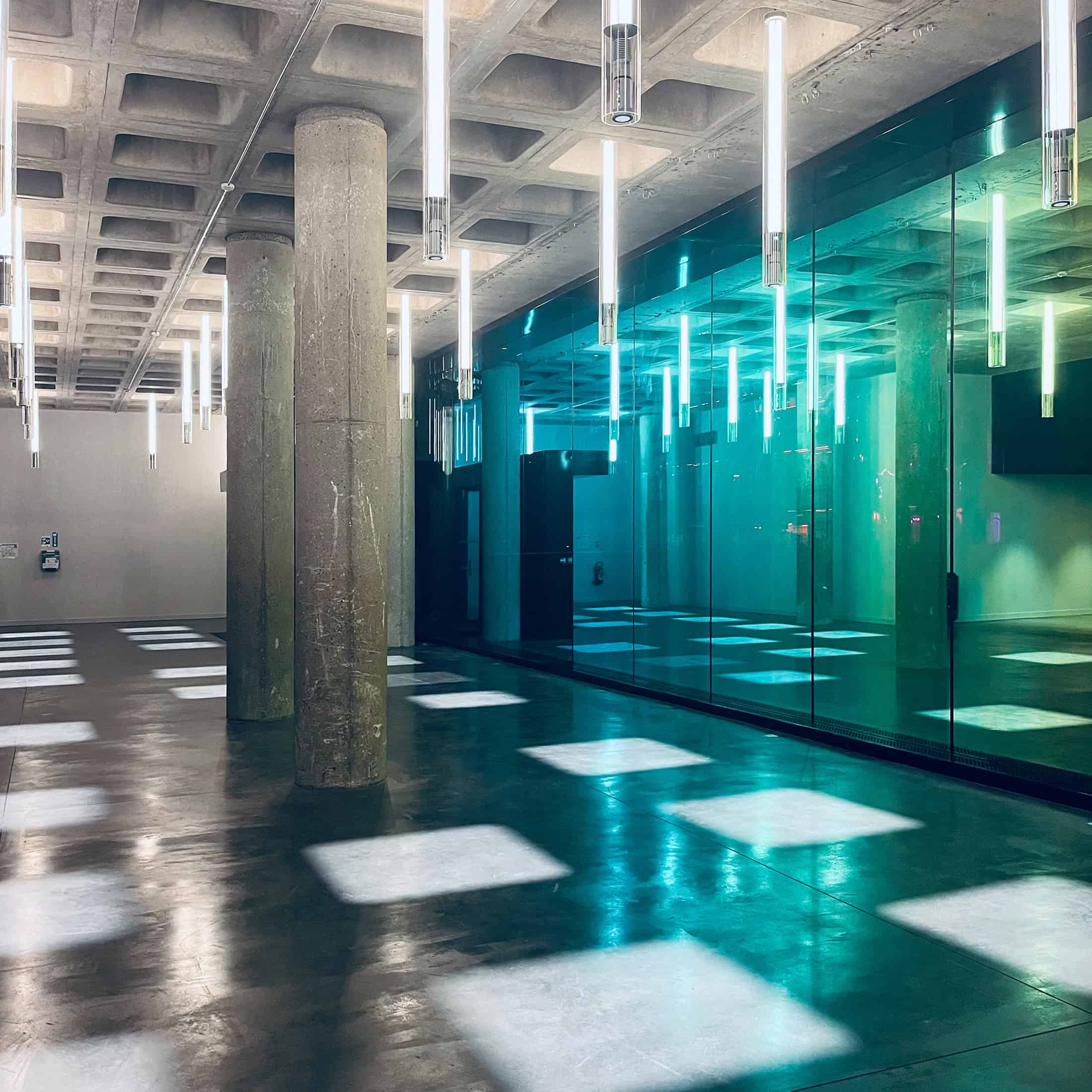 Geode Minimal Lobby Green Glass Minimalist glass lobby space with geometric lighting inside La Géode.