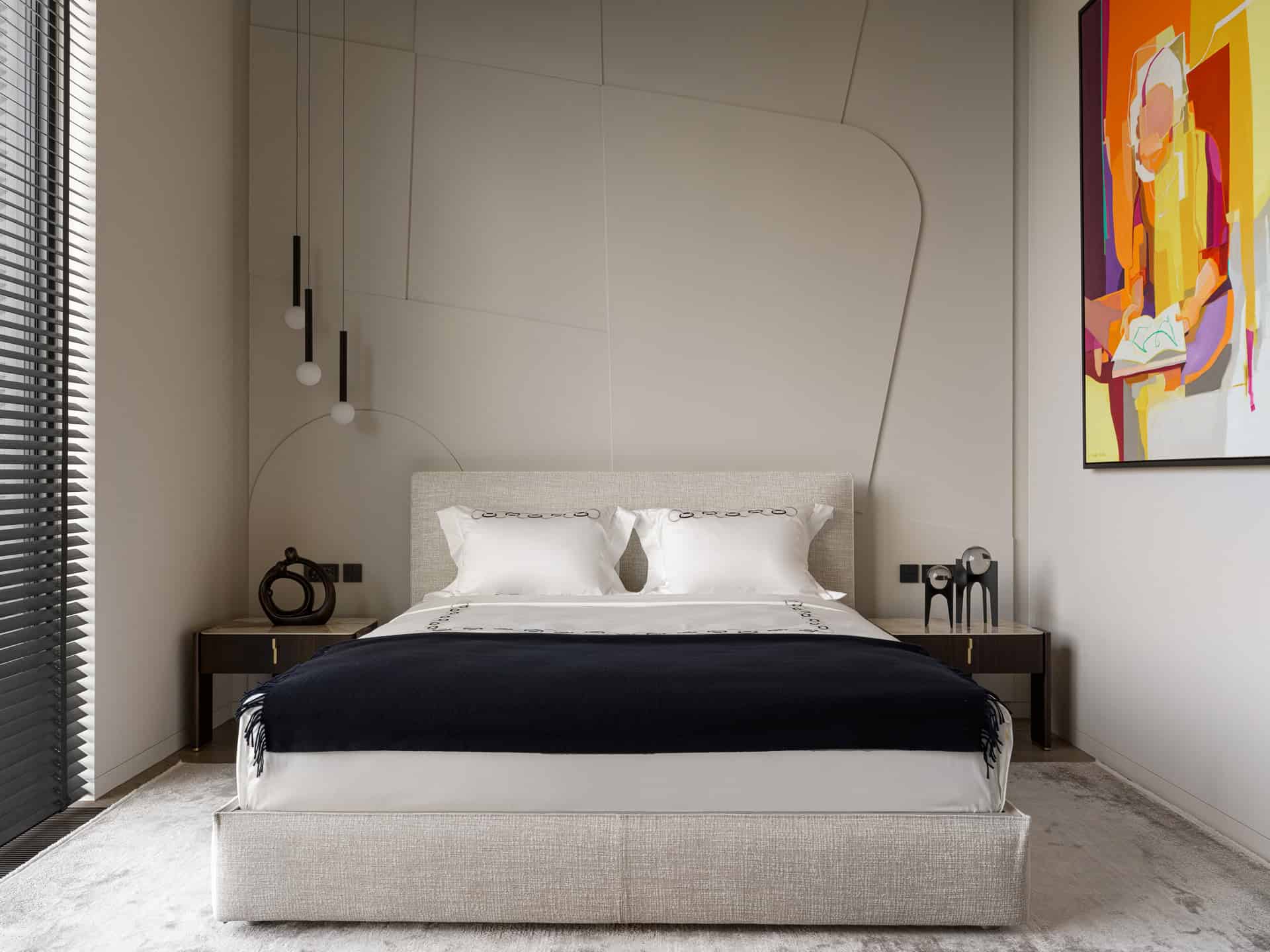 Geometric Wall Bedroom with Art Modern bedroom with geometric wall patterns and a colorful abstract painting.