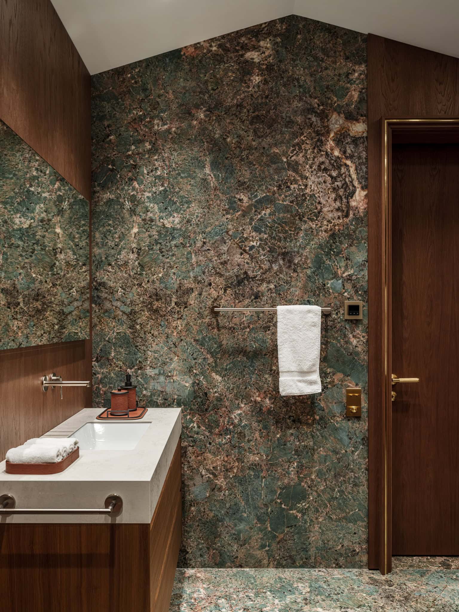 Green Marble Wall in Luxury Bathroom Luxury bathroom with rich green marble walls and wood detailing.