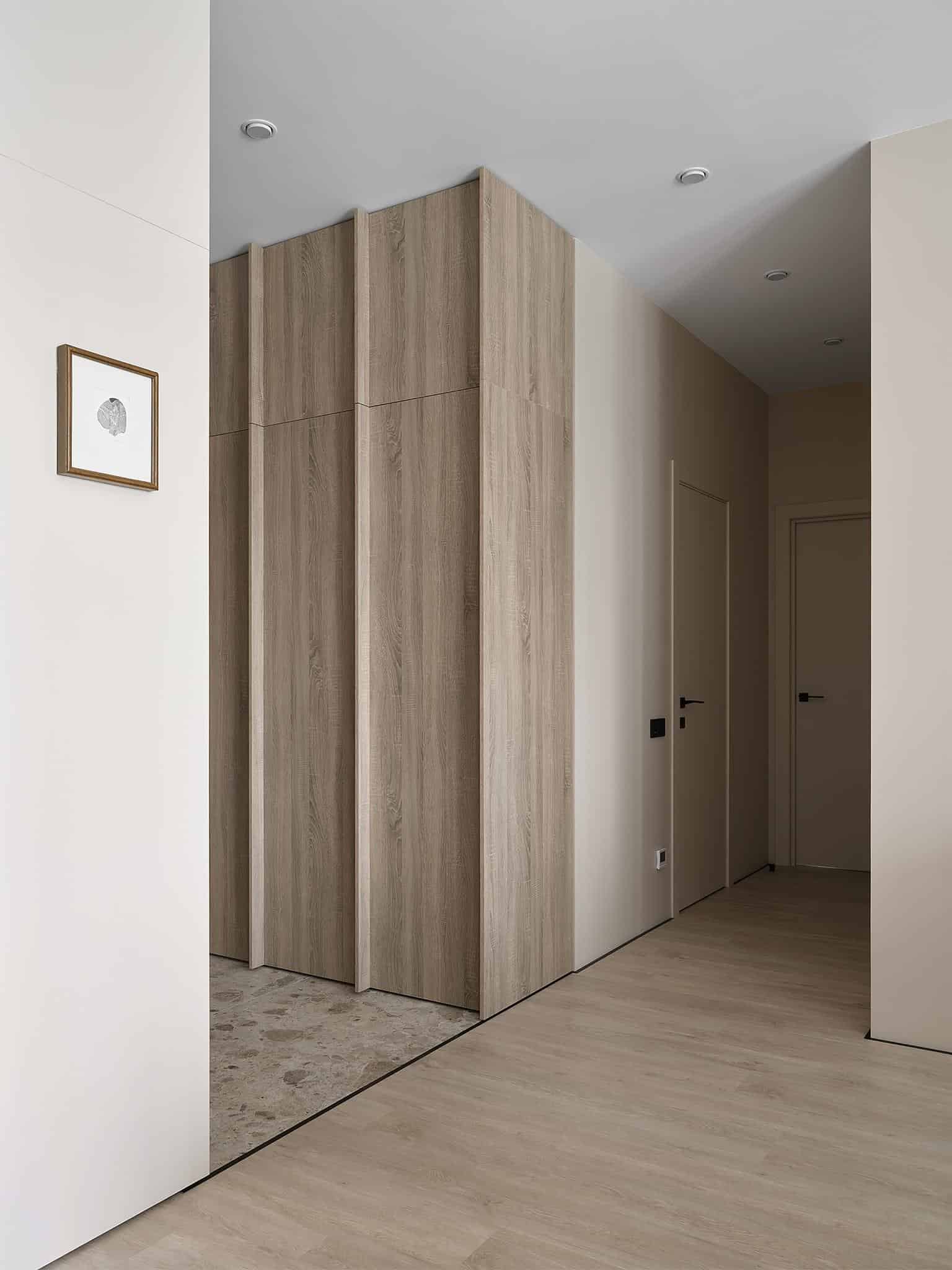 Hallway Design with Wood Paneling and Recessed Lighting Stylish hallway with wood paneling and soft recessed lighting in a neutral interior.