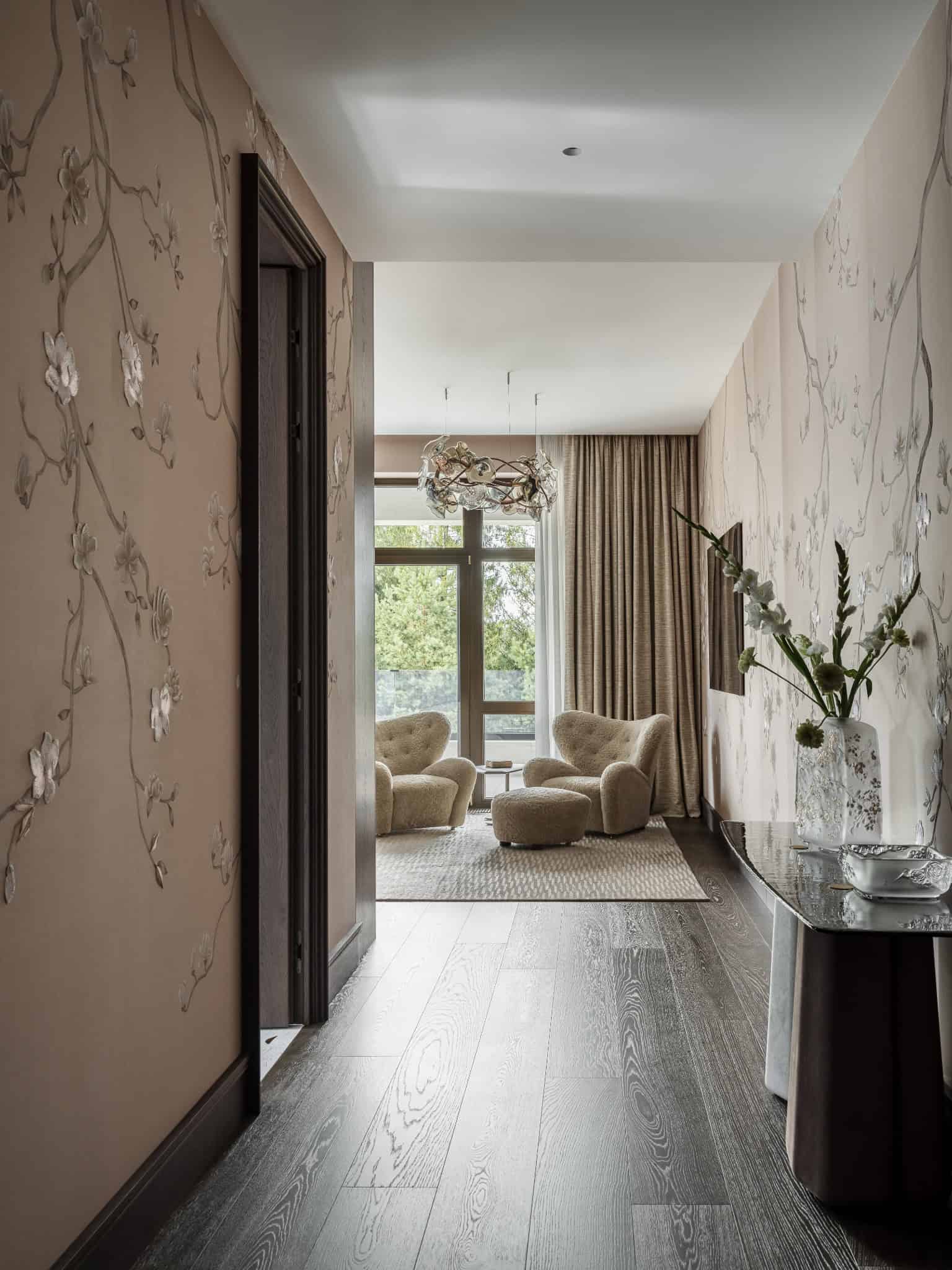 Hallway with Textured Walls and Accent Lighting Hallway with floral wall textures, dark floors, and warm natural light.