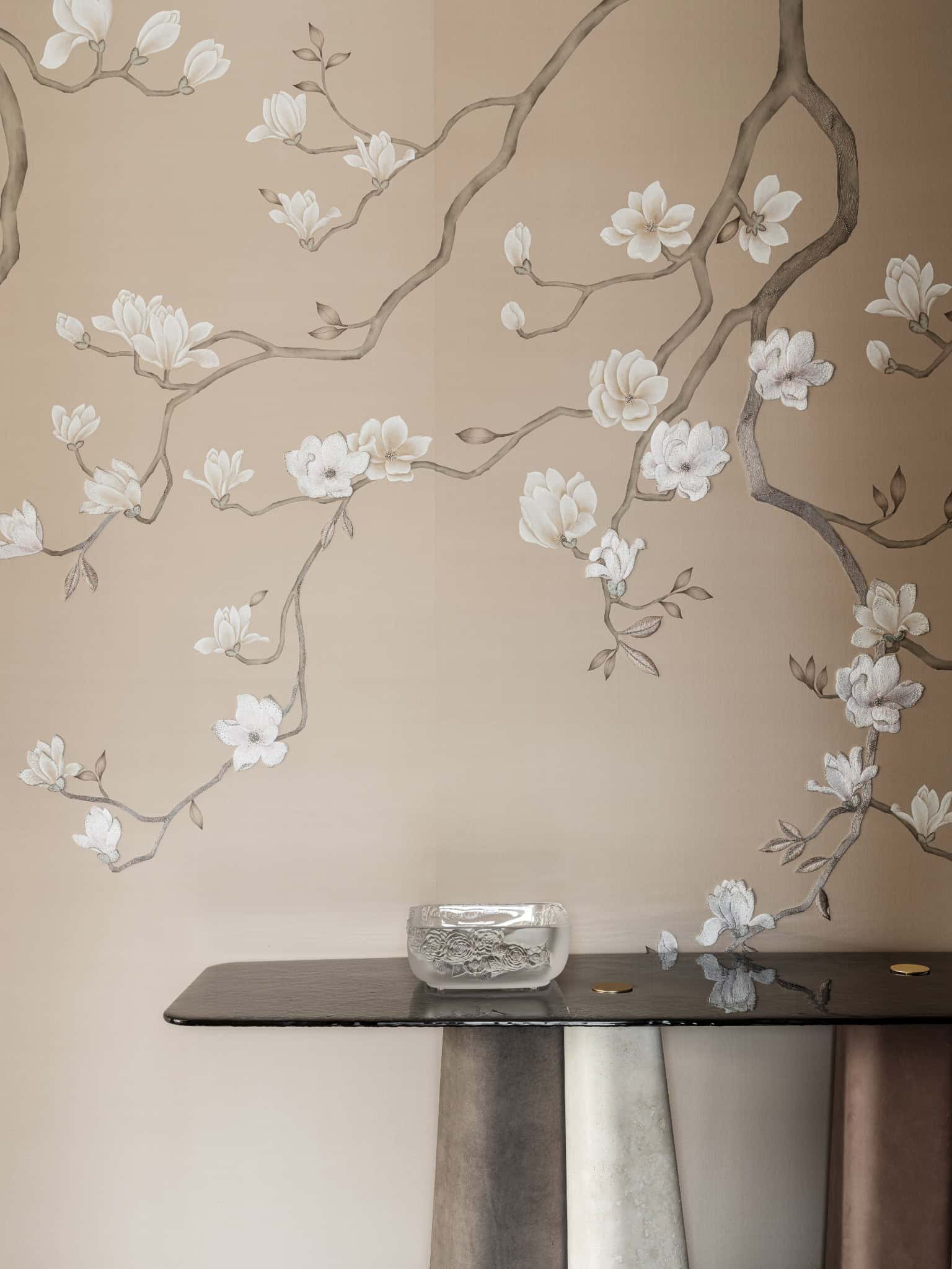 Hand-Painted Wall Mural Behind Console Decorative wall mural with blossoming branches behind a sculptural black console.