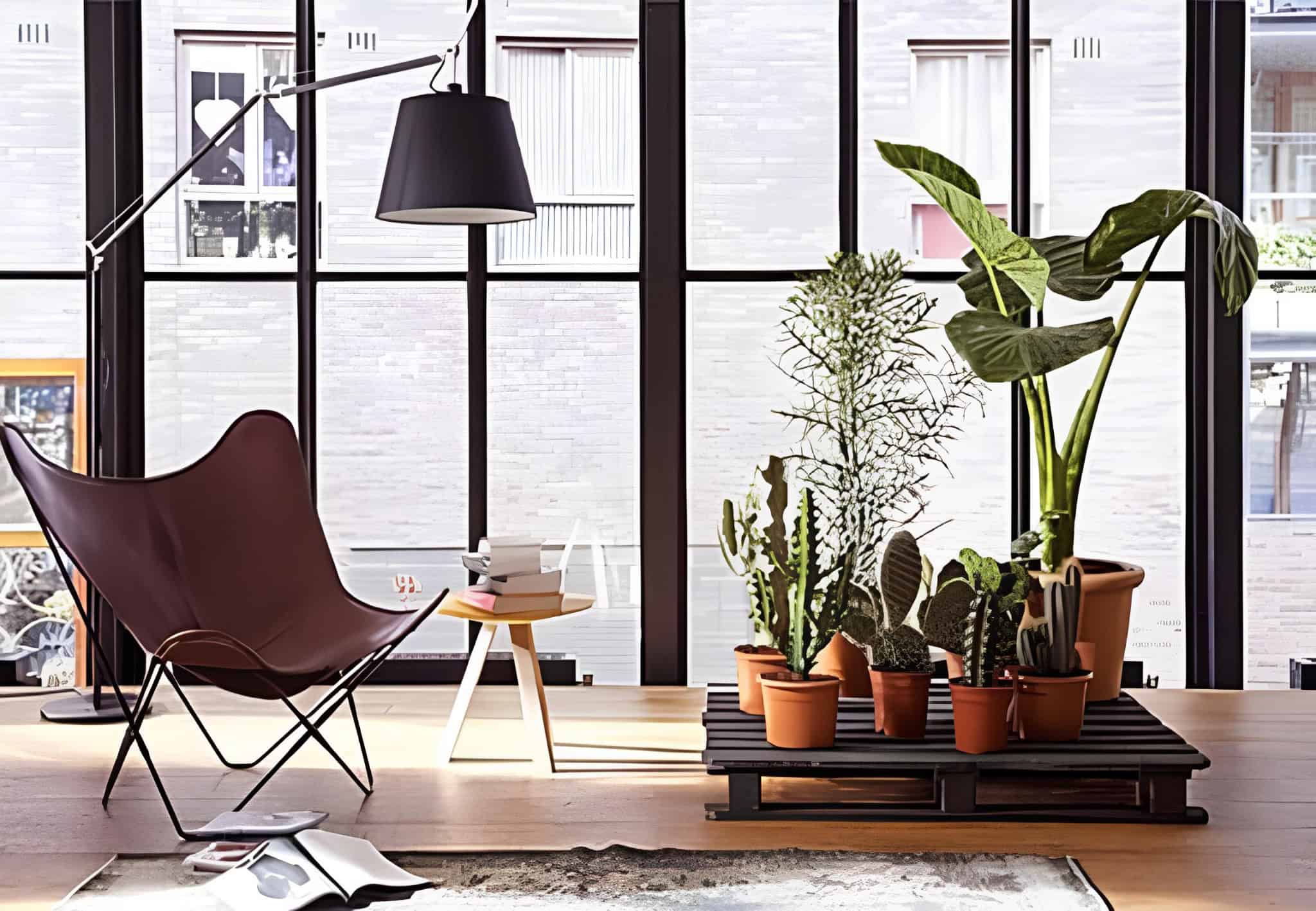 Modern plant stand crafted from a dark-stained pallet, ideal for indoor potted greenery.