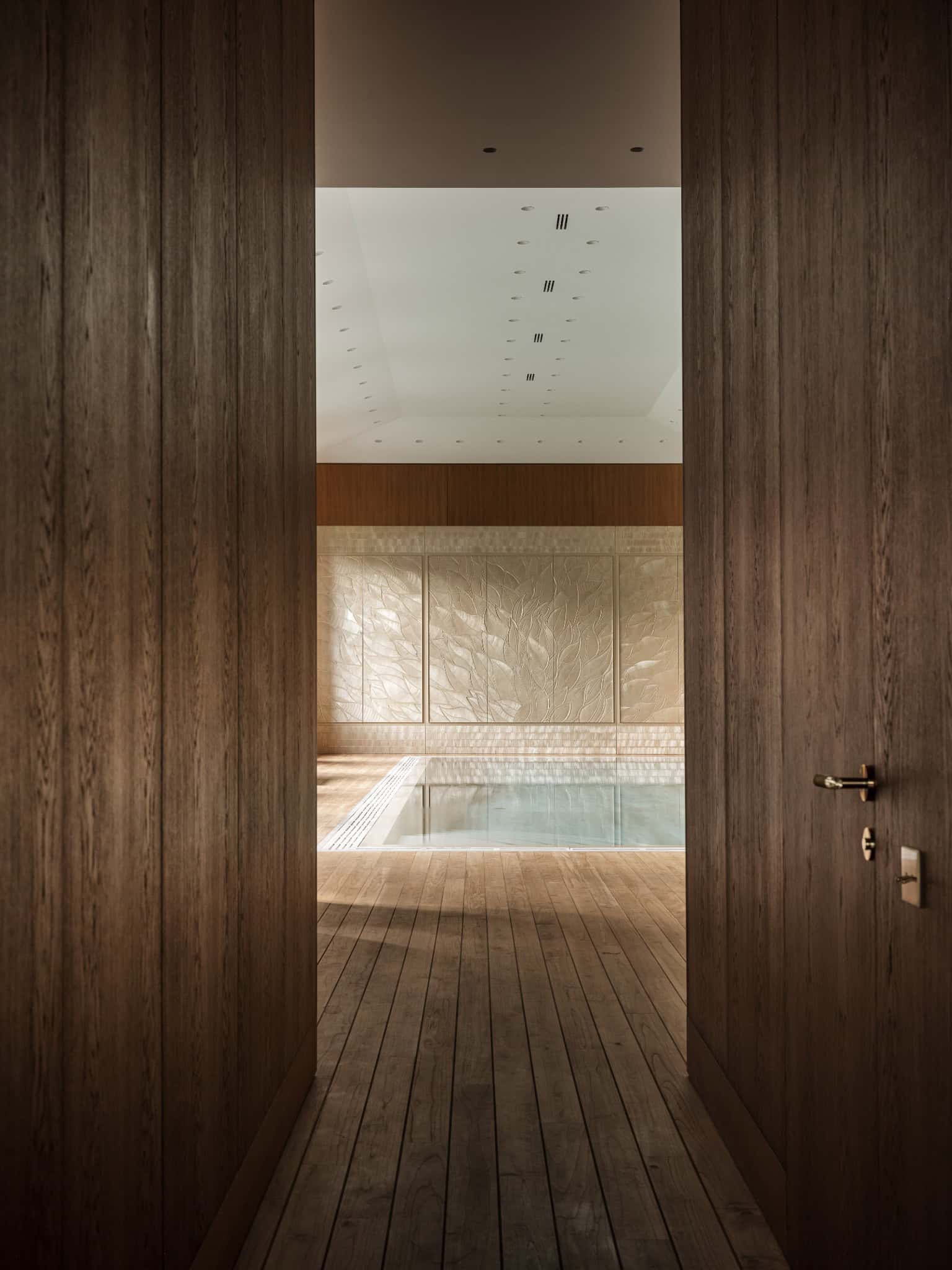 Indoor Pool Entrance with Wood Floor Entrance to luxurious indoor pool framed in warm wood flooring.