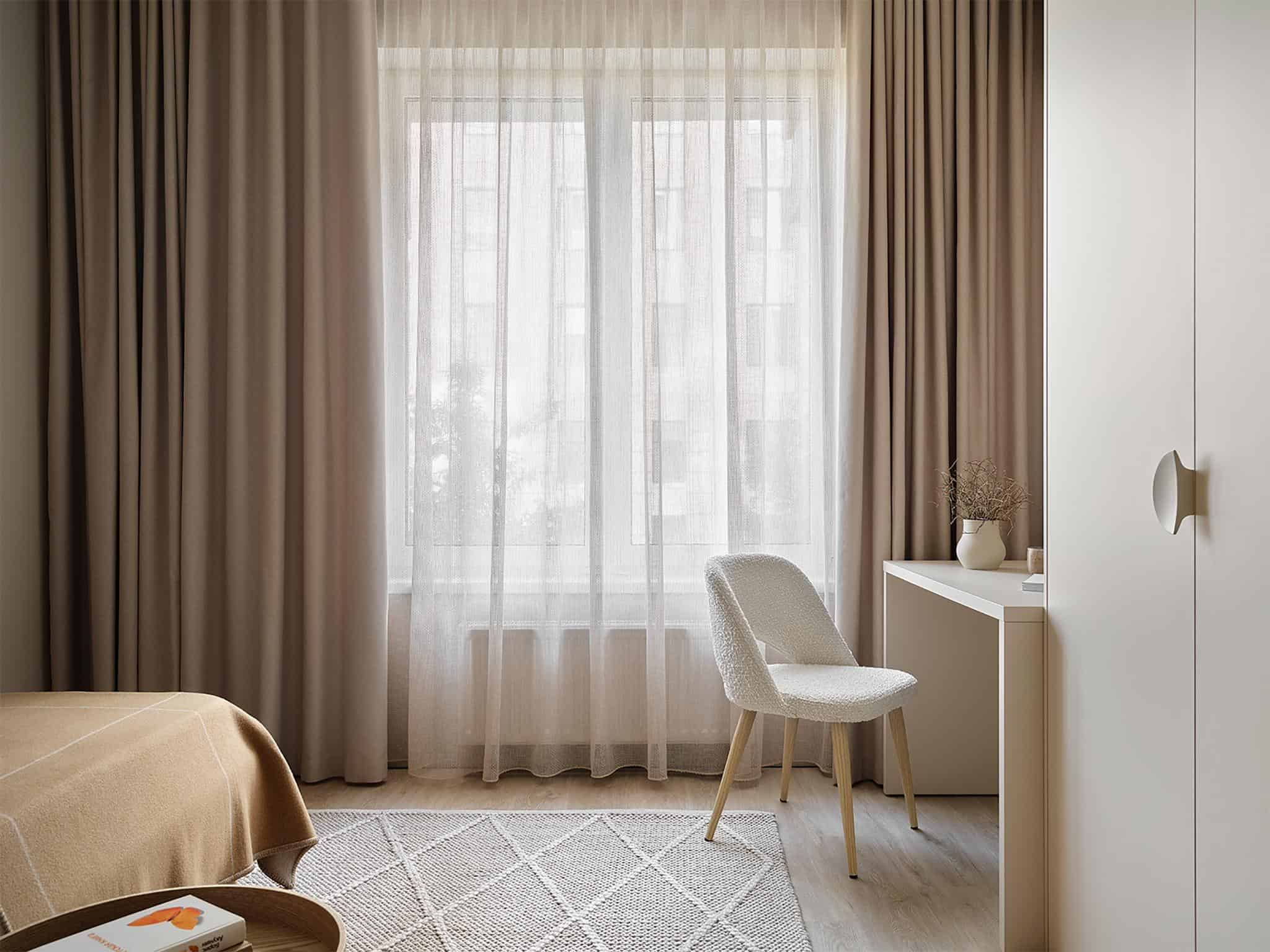 Kids Room Window and Desk Area in Beige Tones Softly lit kids room with desk and beige-toned curtains and rug.