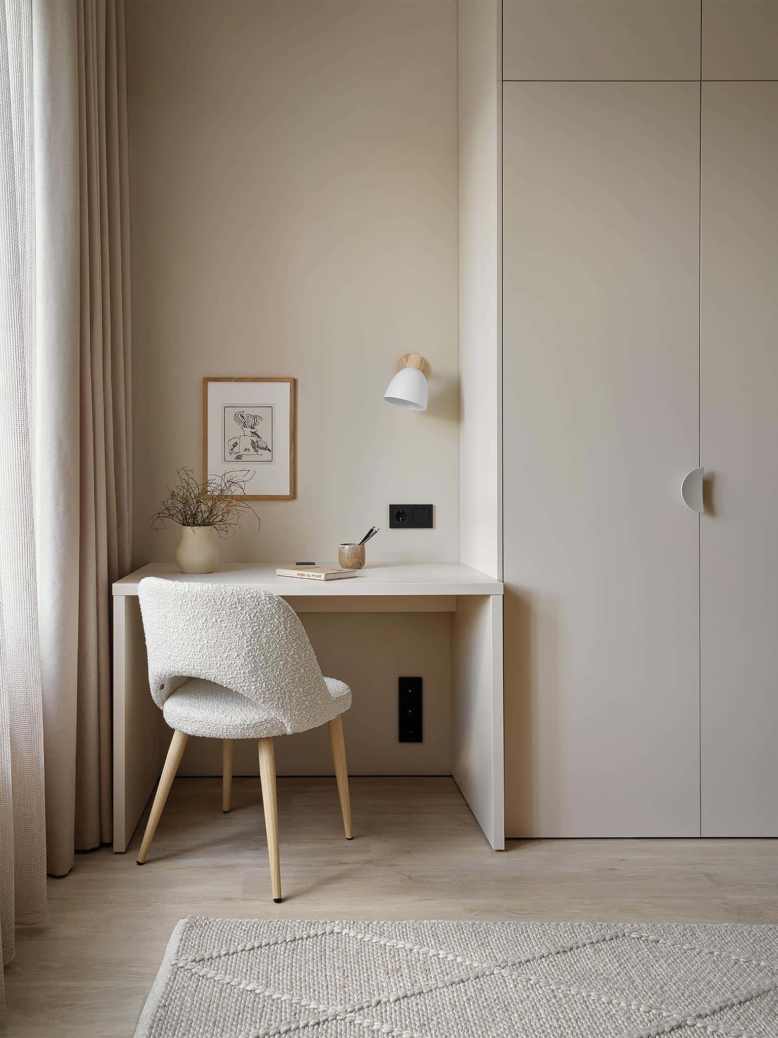 Kids Study Corner with Minimalist Chair Cozy children's study nook with built-in desk, soft chair, and neutral tones.