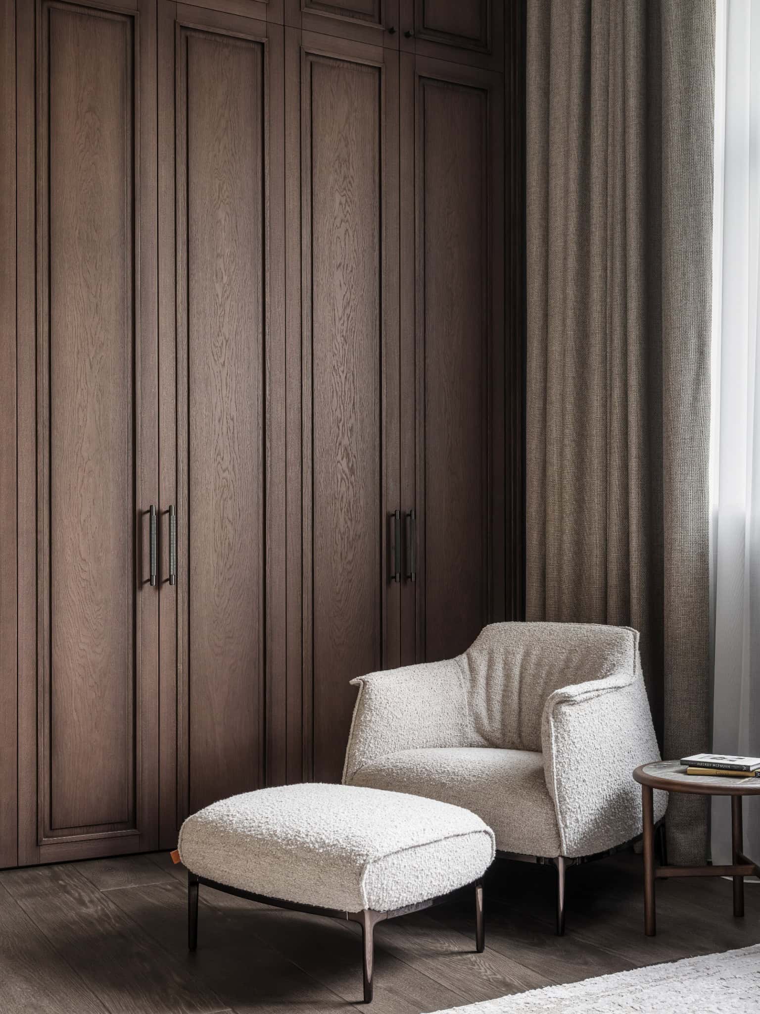 Linen Closet Nook with Shearling Chair Cozy reading nook with soft shearling armchair in front of a built-in wardrobe.